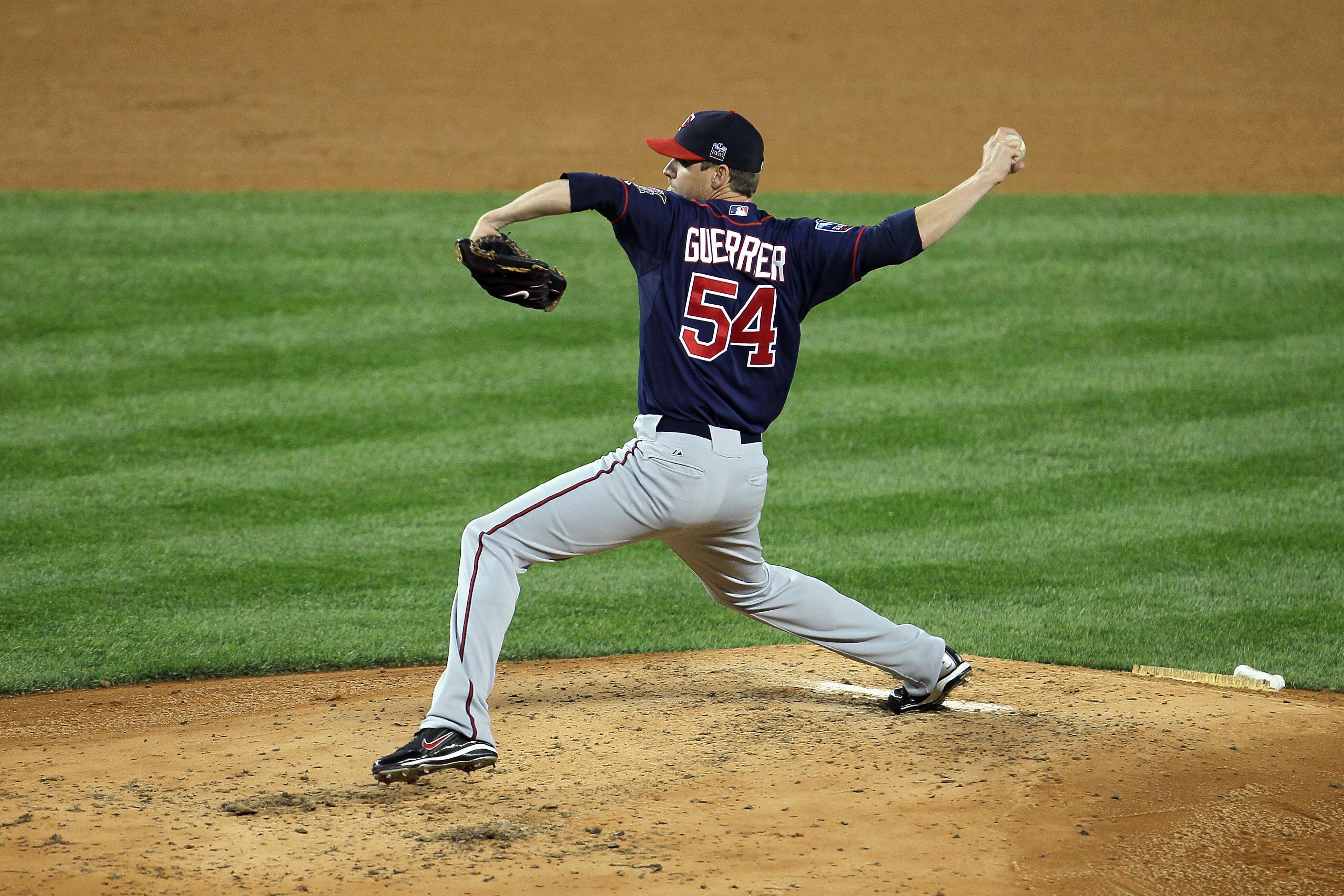 NEW YORK - OCTOBER 09:  Matt Guerrier #54 of the Minnesota Twins throws a pitch against the New York Yankees during Game Three of the ALDS part of the 2010 MLB Playoffs at Yankee Stadium on October 9, 2010 in the Bronx borough of New York City.  (Photo by