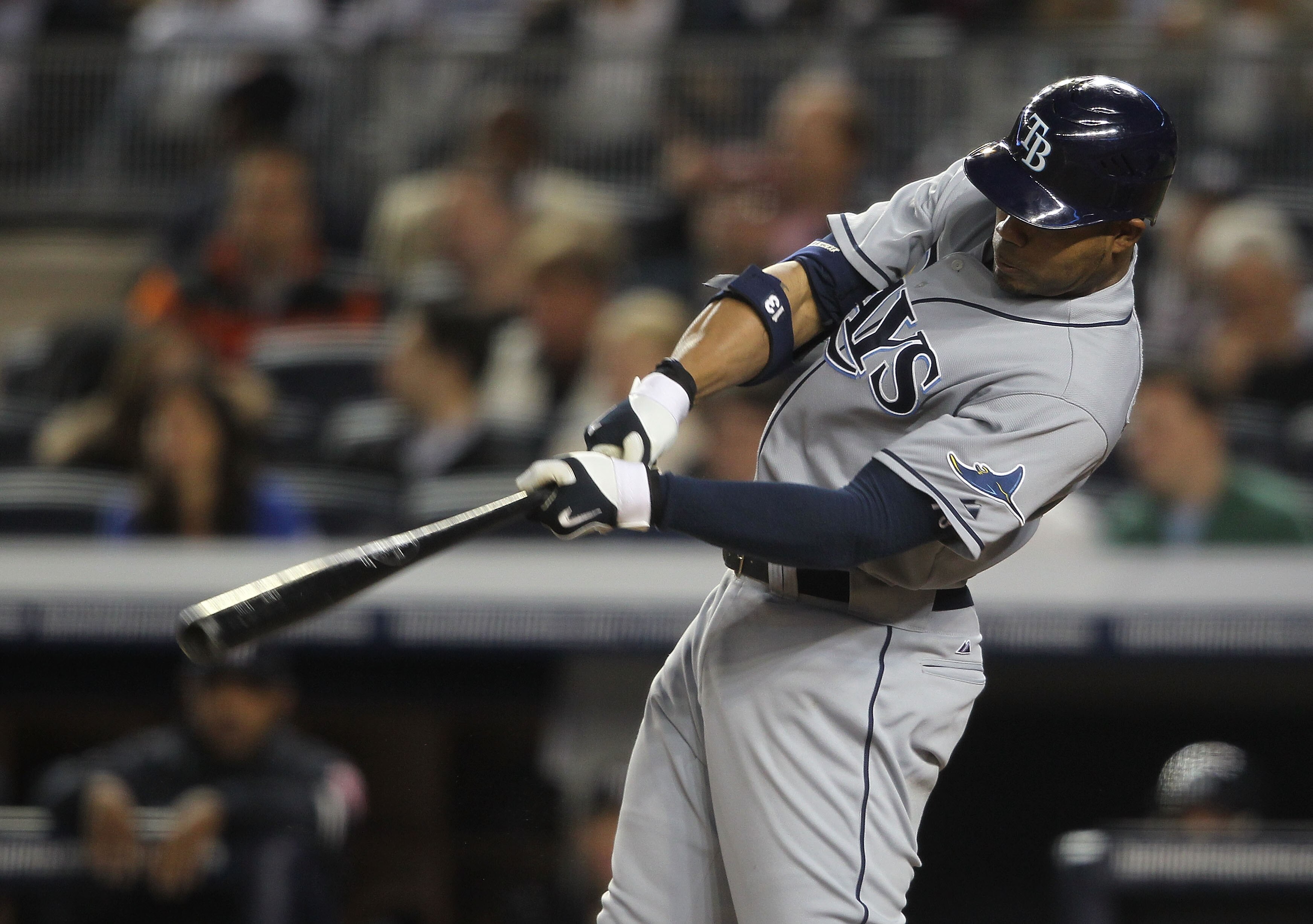 NEW YORK - MAY 19: Carl Crawford #13 of the Tampa Bay Rays hits an RBI double against the New York Yankees at Yankee Stadium on May 19, 2010 in the Bronx borough of New York City.  (Photo by Nick Laham/Getty Images)