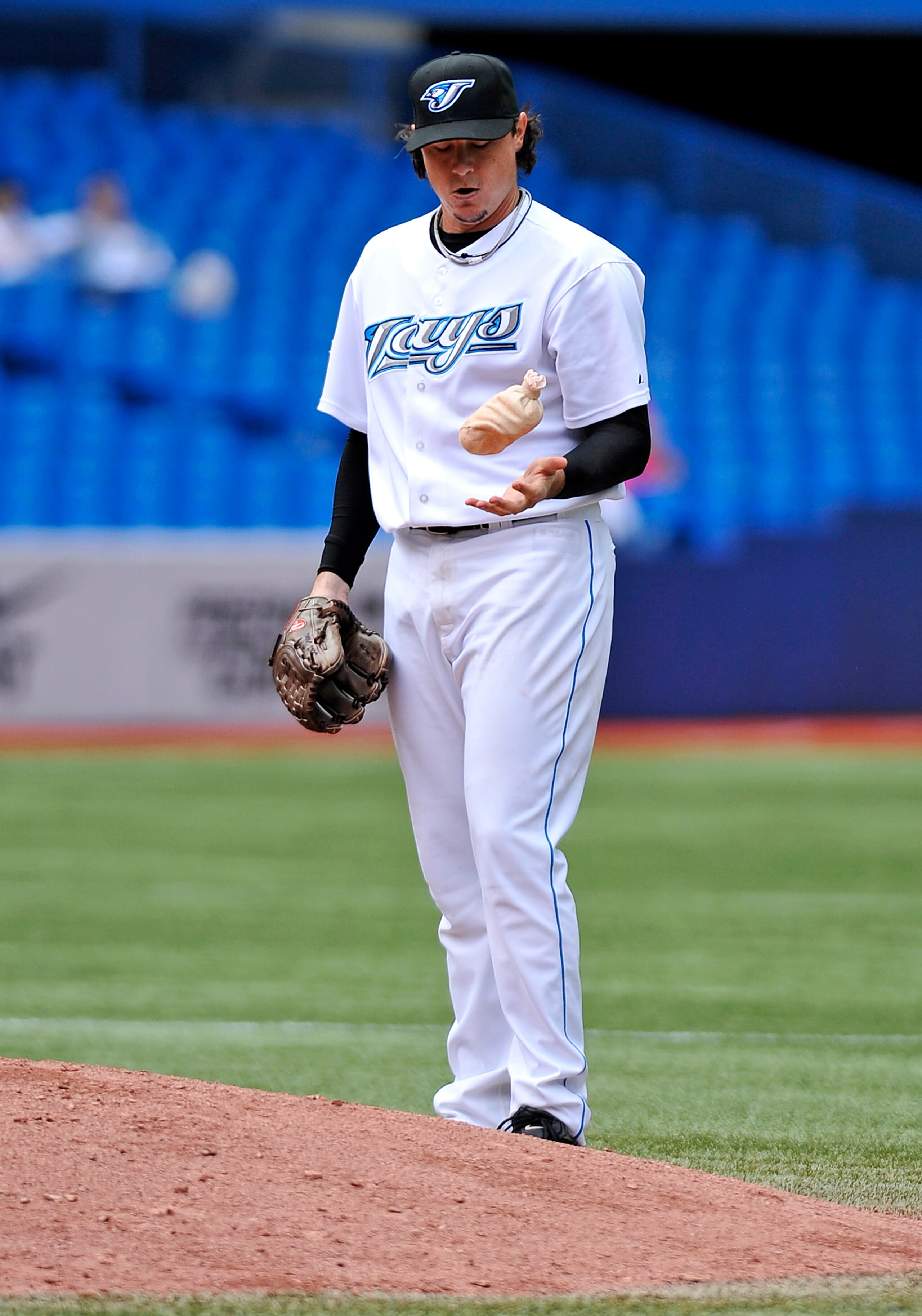 TORONTO - SEPTEMBER 23:   Pitcher Scott Downs #37 of the Toronto Blue Jays tosses the rosin bag during a break in game action against the Seattle Mariners on September 23, 2010 at Rogers Centre in Toronto, Ontario, Canada. The Blue Jays defeated the Marin