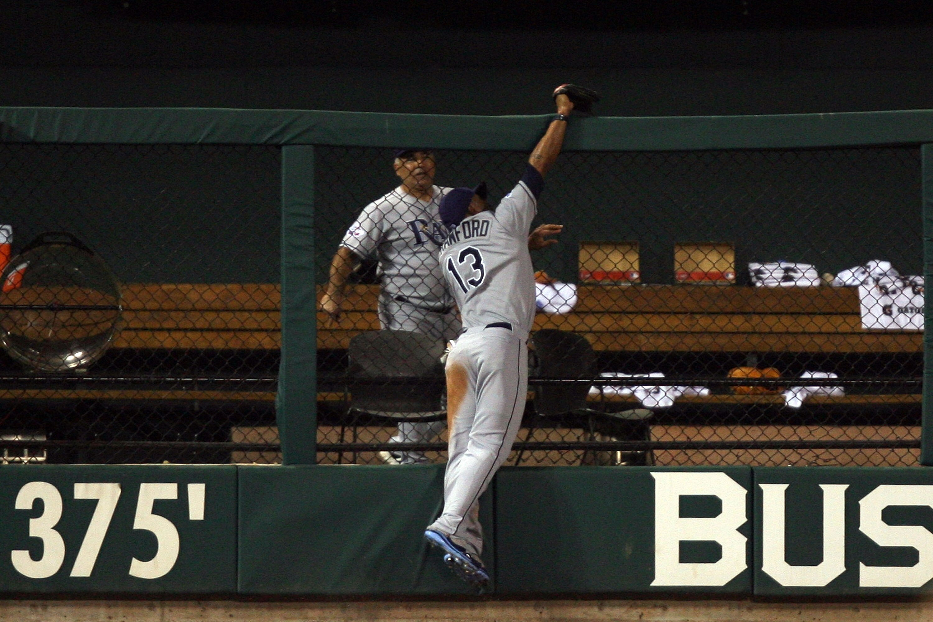 ST LOUIS, MO - JULY 14:  American League All-Star Carl Crawford of the Tampa Bay Rays robs a home run from National League All-Star Brad Hawpe of the Colorado Rockies during the 2009 MLB All-Star Game at Busch Stadium on July 14, 2009 in St Louis, Missour