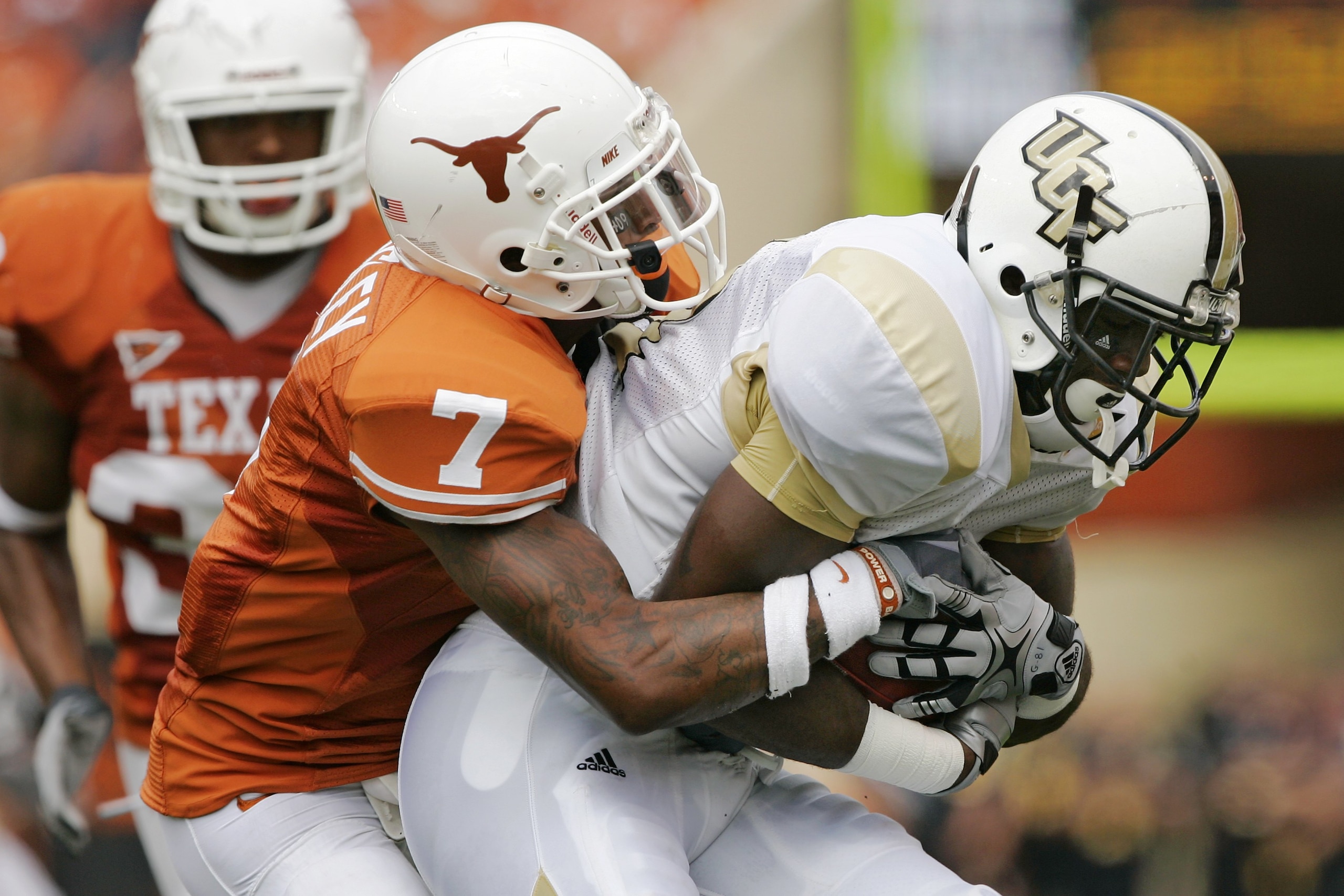 AUSTIN, TX - NOVEMBER 07:  Cornerback Deon Beasley #7 of the Texas Longhorns stops wide receiver Kamar Aiken #81 of the UCF Knights on November 7, 2009 at Darrell K Royal - Texas Memorial Stadium in Austin, Texas.  Texas won 35-3.  (Photo by Brian Bahr/Ge