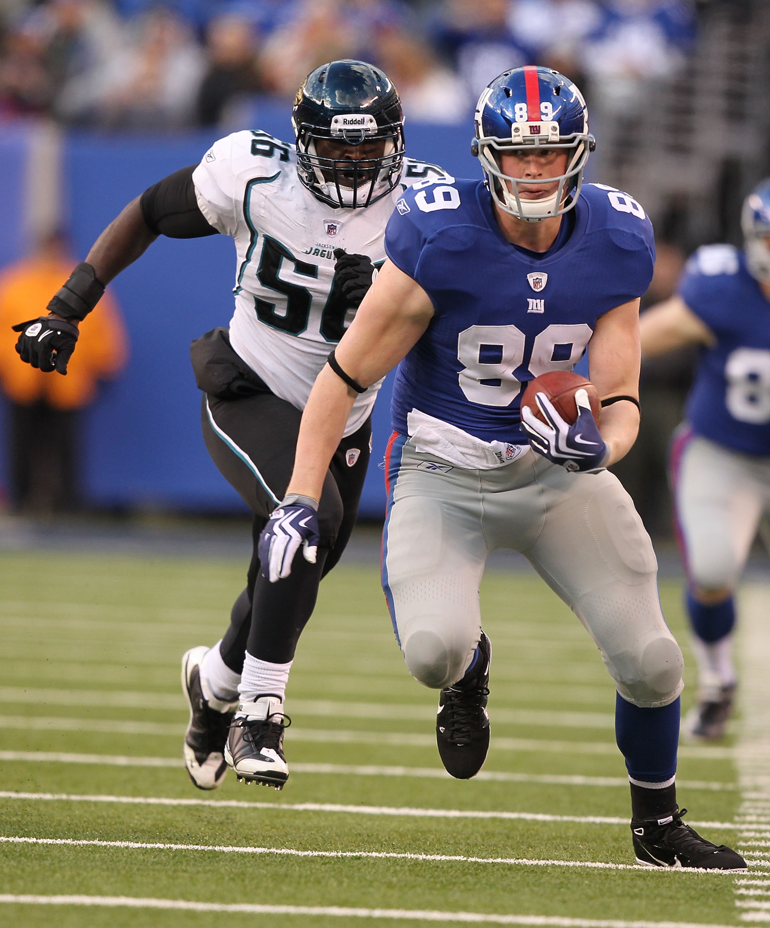 EAST RUTHERFORD, NJ - NOVEMBER 28:  Kevin Boss #89  of the New York Giants runs with the ball as Justin Durant #56 of the Jacksonville Jaguars trails during their game on November 28, 2010 at The New Meadowlands Stadium in East Rutherford, New Jersey.  (P