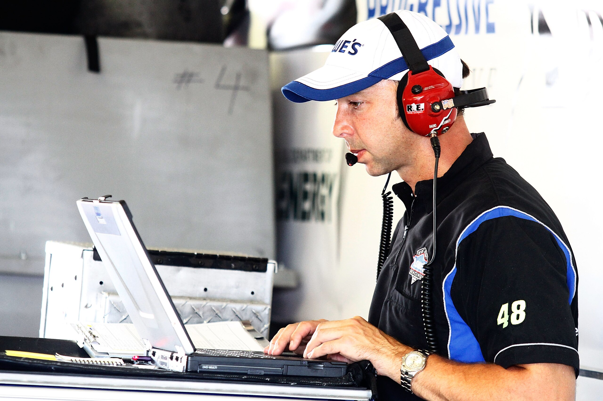 BROOKLYN, MI - AUGUST 13:  Chad Knaus, crew cheif of the the #48 Lowe's Chevrolet driven by Jimmie Johnson (not pictured) works on a laptop in the garage during practice for the NASCAR Sprint Cup Series CARFAX 400 at Michigan International Speedway on Aug