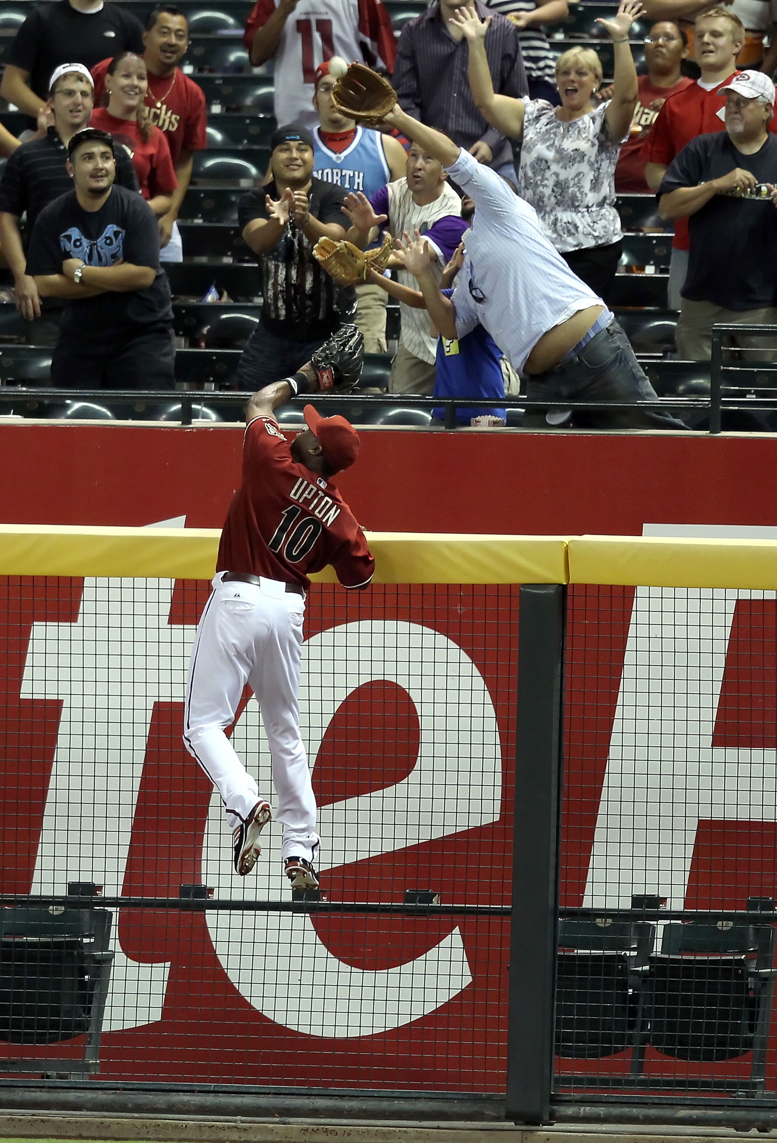PHOENIX - AUGUST 18:  Outfielder Justin Upton #10 of the Arizona Diamondbacks attempts to catch a home run hit by Jay Bruce (not pictured) of the Cincinnati Reds during the fourth inning of the Major League Baseball game at Chase Field on August 18, 2010
