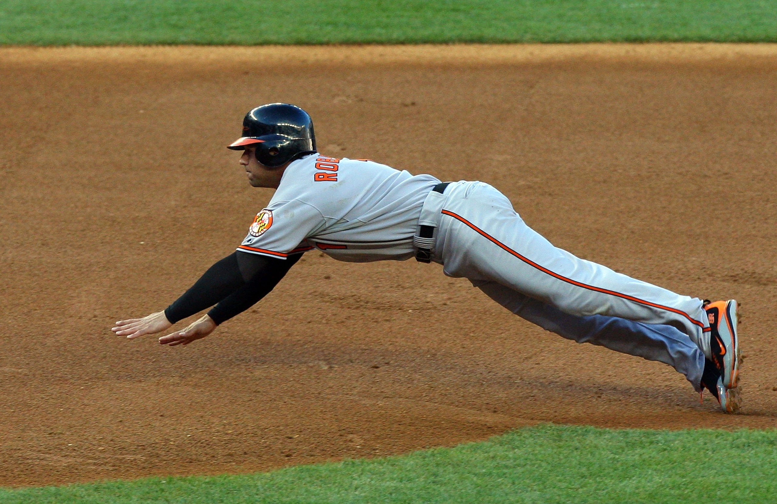 NEW YORK - MAY 19:  Brian Roberts #1 of the Baltimore Orioles steals third base in the first inning against the New York Yankees at Yankee Stadium May 19, 2009 in the Bronx borough of New York City.  (Photo by Jim McIsaac/Getty Images)