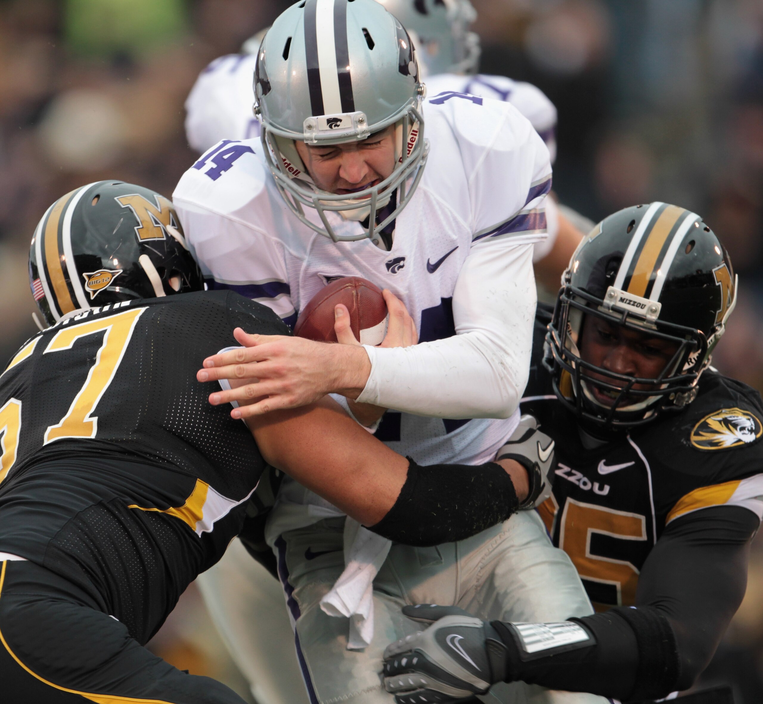 COLUMBIA, MO - NOVEMBER 13:  Quarterback Carson Coffman #14 of the Kansas State Wildcats is sacked by Brad Madison #57 and Aldon Smith #85 of the Missouri Tigers during the game on November 13, 2010 at Faurot Field/Memorial Stadium in Columbia, Missouri.