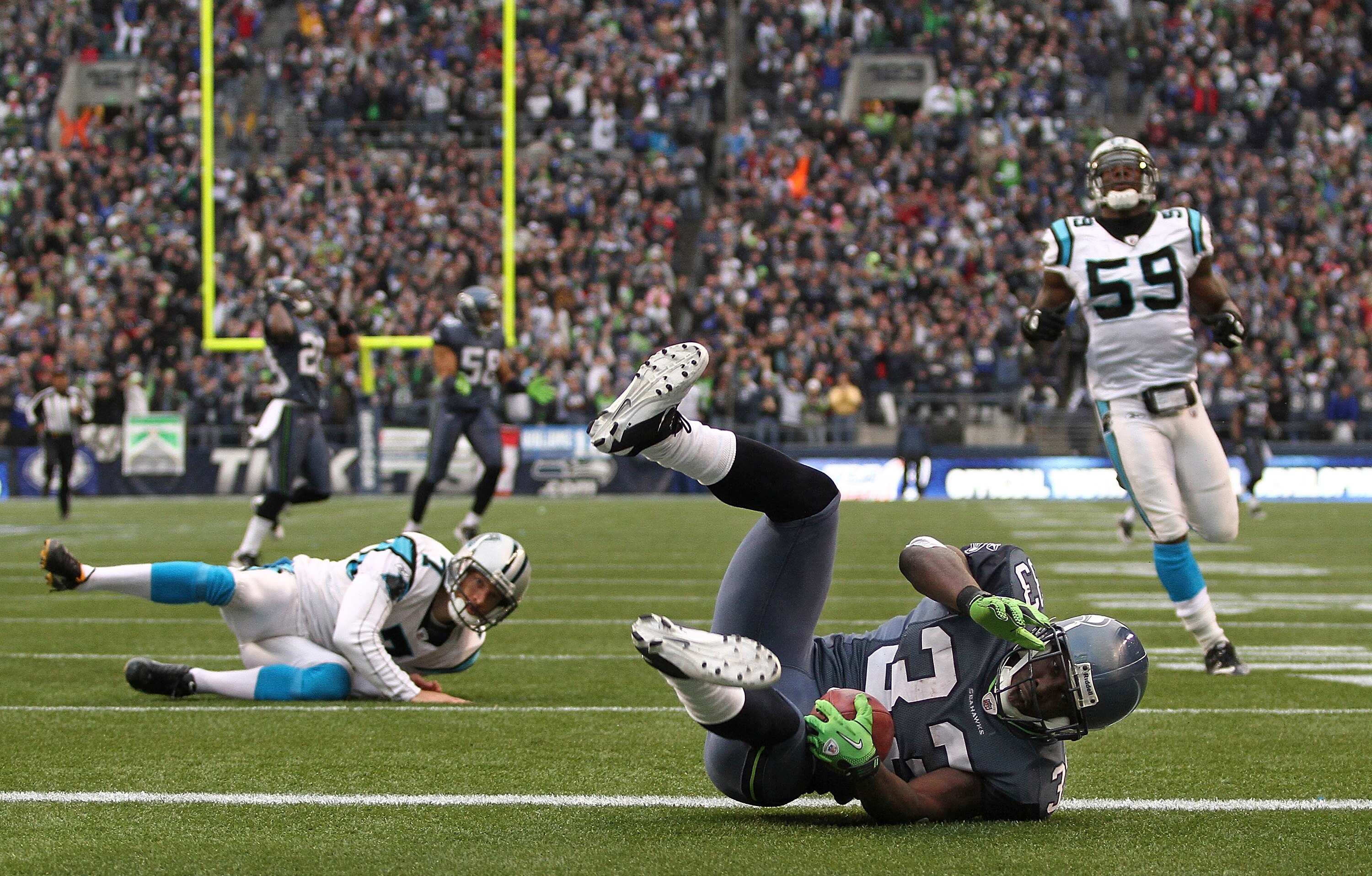 SEATTLE, WA - DECEMBER 05:  Running back Leon Washington #33 of the Seattle Seahawks tumbles over the goal line after returning a punt for 84 yards against the Carolina Panthers at Qwest Field on December 5, 2010 in Seattle, Washington. Washington was dow