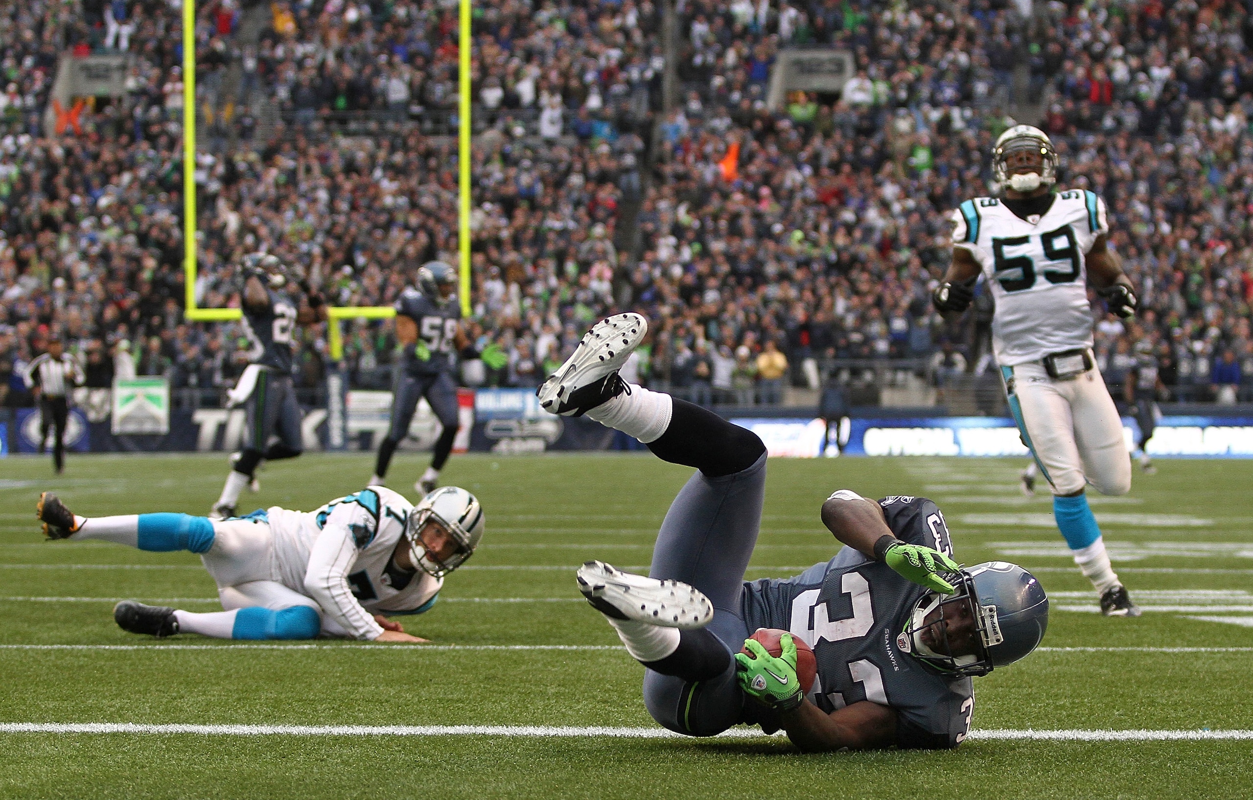 SEATTLE, WA - DECEMBER 05:  Running back Leon Washington #33 of the Seattle Seahawks tumbles over the goal line after returning a punt for 84 yards against the Carolina Panthers at Qwest Field on December 5, 2010 in Seattle, Washington. Washington was dow