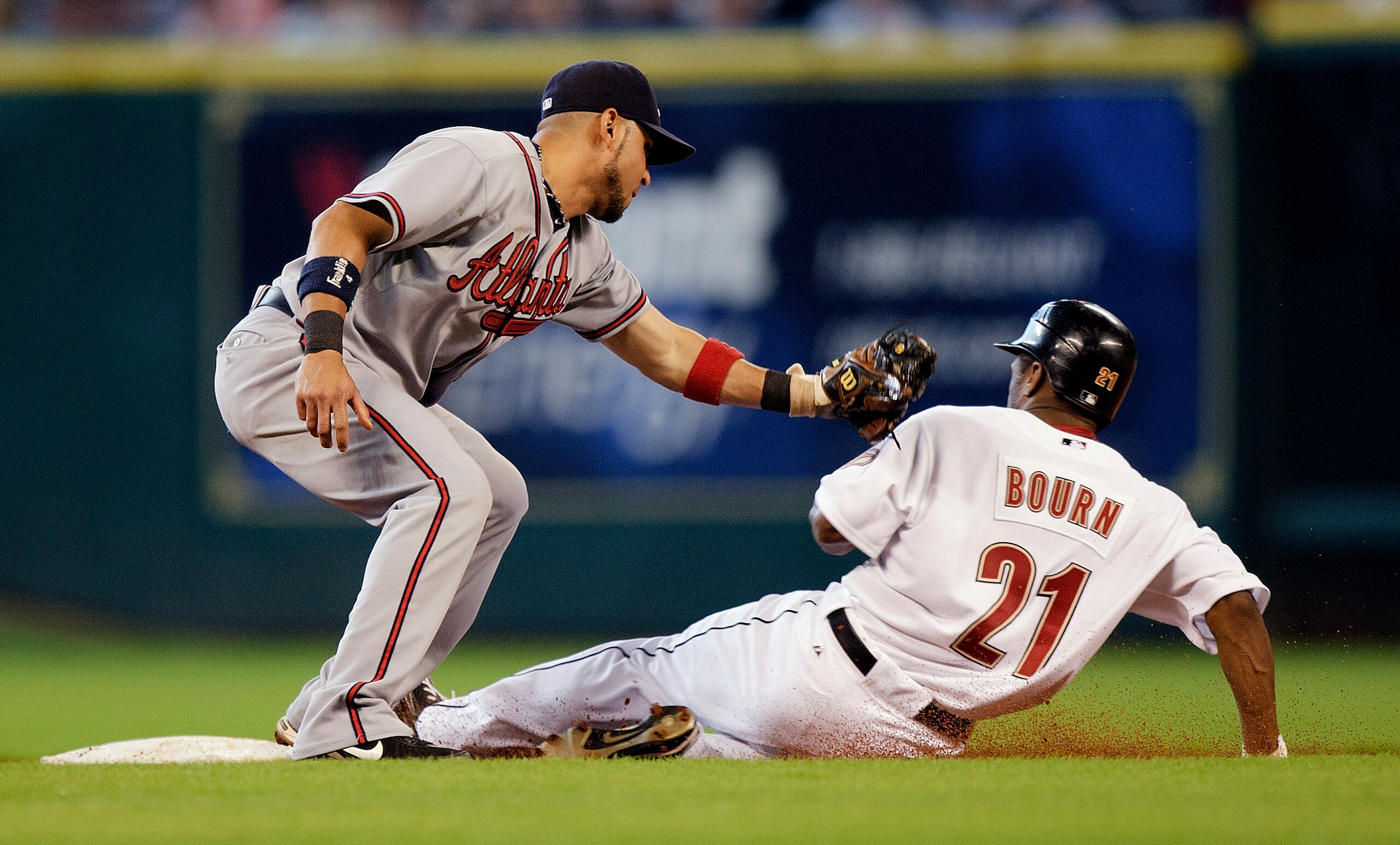 HOUSTON - AUGUST 11:  Michael Bourn #21 of the Houston Astros steals second base as shortstop Alex Gonzalez #2 ofthe Atlanta Braves applies the tag at Minute Maid Park on August 11, 2010 in Houston, Texas.  (Photo by Bob Levey/Getty Images)