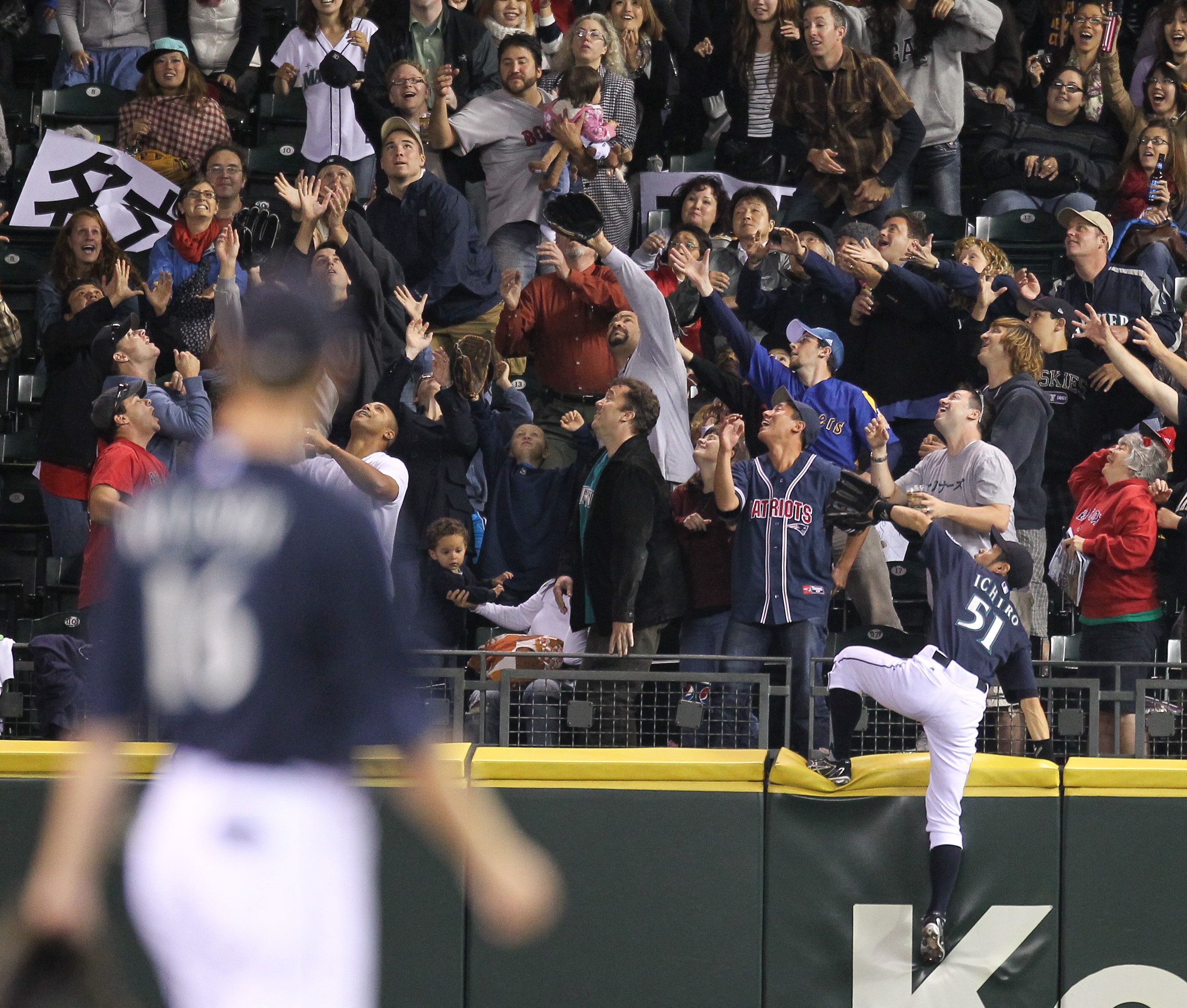SEATTLE - SEPTEMBER 13:  Ichiro Suzuki #51 of the Seattle Mariners climbs the fence attempting to catch a two-run homer by Ryan Kalish of the Boston Red Sox at Safeco Field on September 13, 2010 in Seattle, Washington. (Photo by Otto Greule Jr/Getty Image