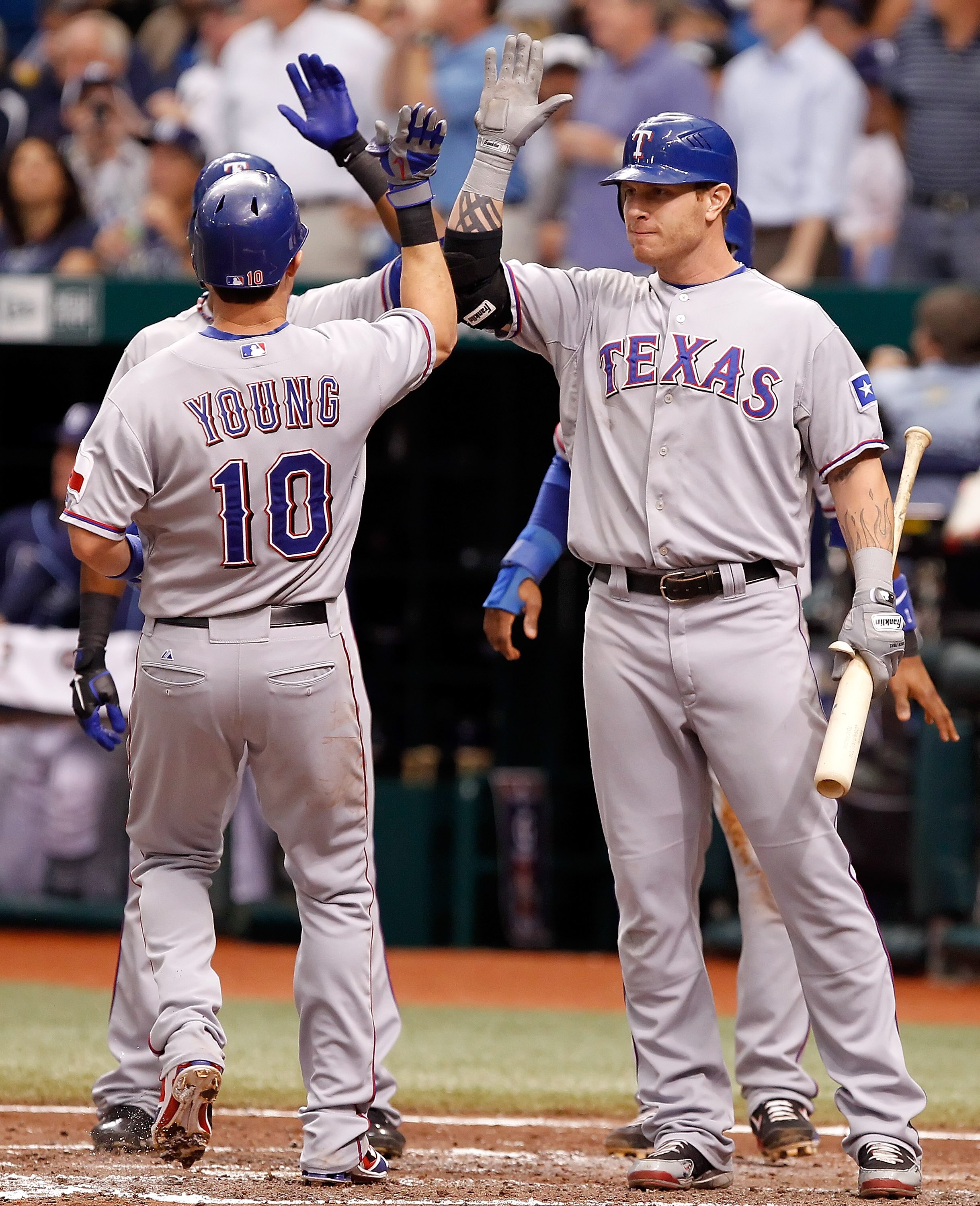 ST PETERSBURG, FL - OCTOBER 07:  Outfielder Josh Hamilton #32 of the Texas Rangers congratulates Michael Young #10 after this three run home run against the Tampa Bay Rays during Game 2 of the ALDS at Tropicana Field on October 7, 2010 in St. Petersburg,