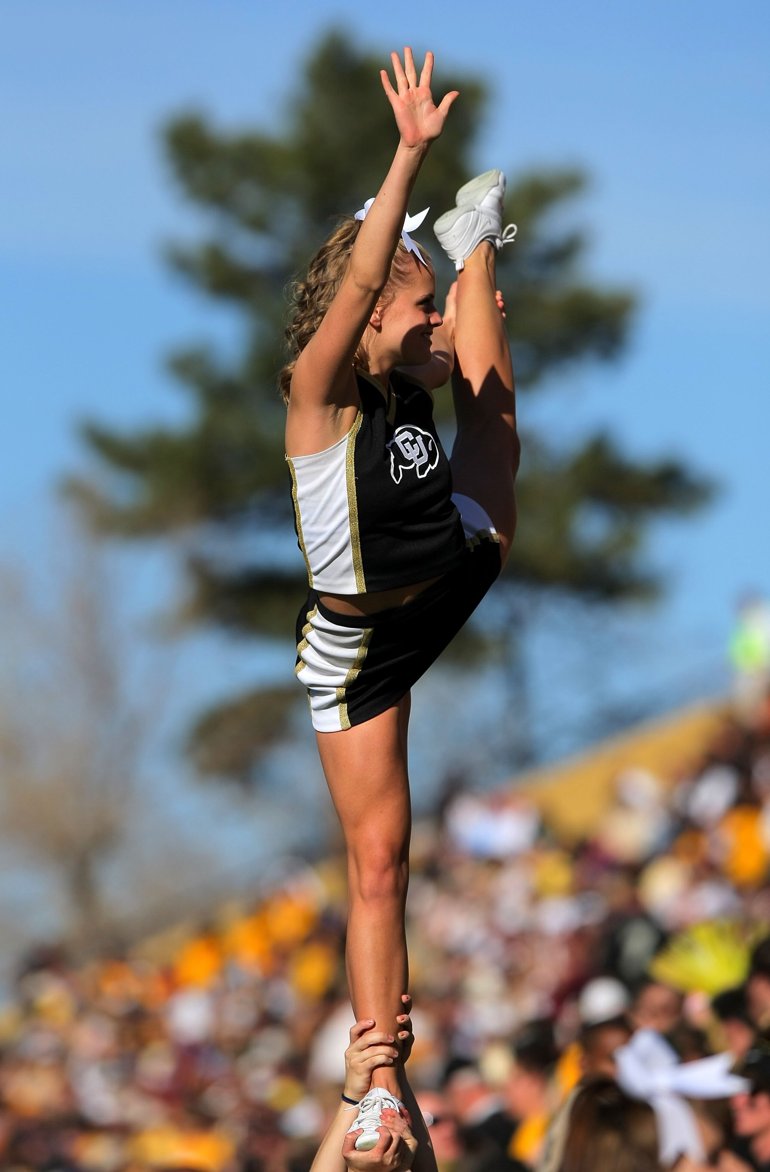 BOULDER, CO - NOVEMBER 07:  A member of the Colorado Buffaloes cheerleaders performs a stunt as the Buffs face the Texas A&M Aggies during NCAA college football action at Folsom Field on November 7, 2009 in Boulder, Colorado. Colorado defeated Texas A&M 3