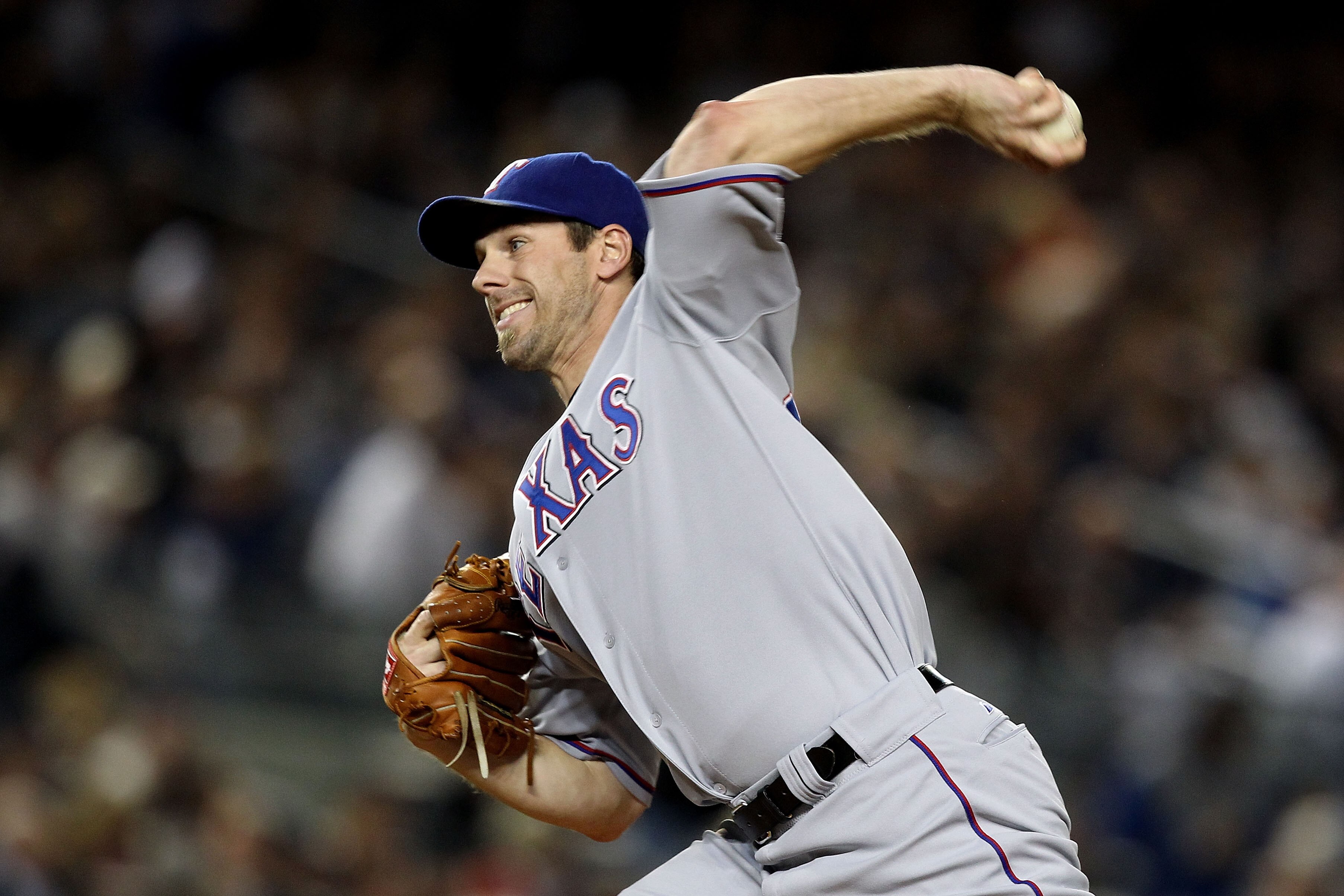 NEW YORK - OCTOBER 18:  Cliff Lee #33 of the Texas Rangers throws a pitch against the New York Yankees in Game Three of the ALCS during the 2010 MLB Playoffs at Yankee Stadium on October 18, 2010 in New York, New York. The Rangers won 8-0.  (Photo by Al B