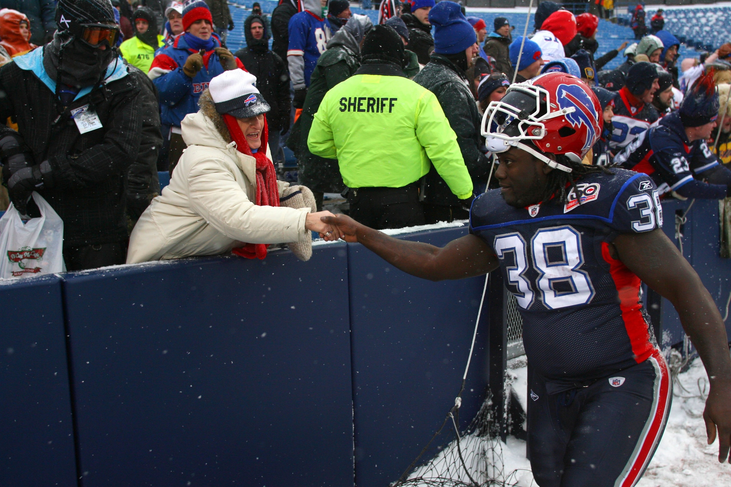 ORCHARD PARK, NY - JANUARY 3:  Corey McIntyre #38 of the Buffalo Bills shakes the hand of a fan their NFL game against Indianapolis Colts at Ralph Wilson Stadium on January 3, 2010 in Orchard Park, New York. The Bills defeated the Colts 30-7. (Photo by Ri