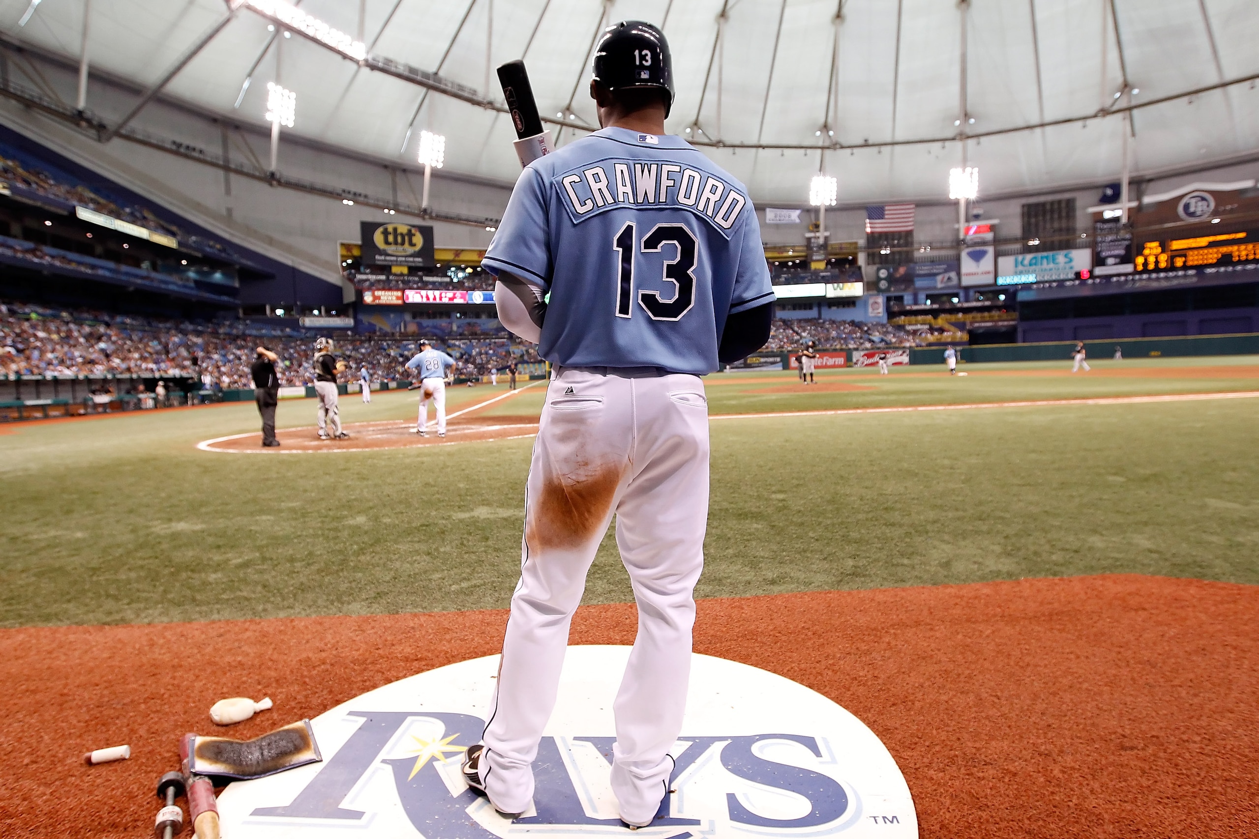 ST. PETERSBURG - JUNE 13:  Outfielder Carl Crawford #13 of the Tampa Bay Rays looks on from the on deck circle against the Florida Marlins during the game at Tropicana Field on June 13, 2010 in St. Petersburg, Florida.  (Photo by J. Meric/Getty Images)