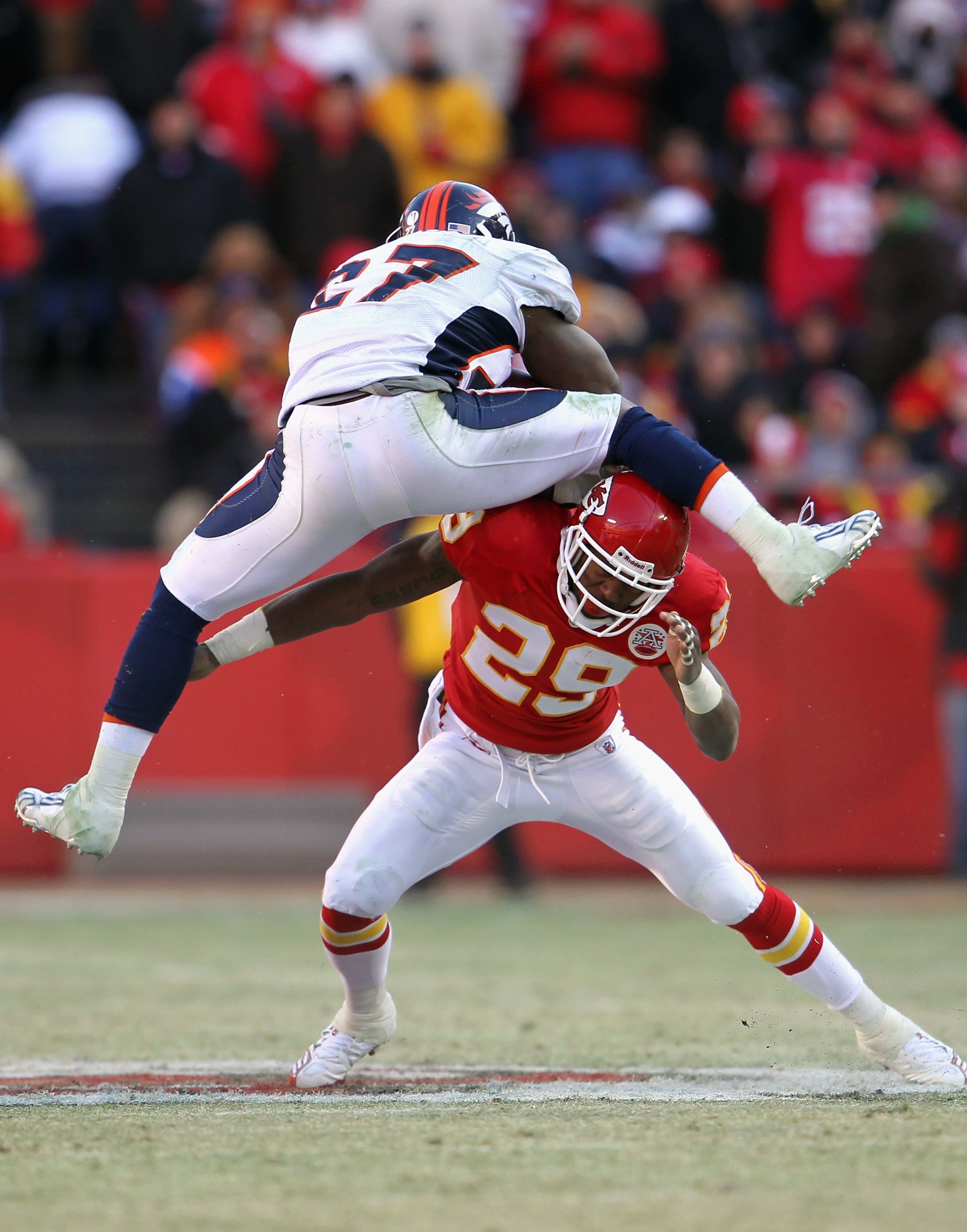 KANSAS CITY, MO - DECEMBER 05:  Knowshon Moreno #27 of the Denver Broncos tries to leap over Eric Berry #29 of the Kansas City Chiefs as he carries the ball during the game on December 5, 2010 at Arrowhead Stadium in Kansas City, Missouri.  (Photo by Jami