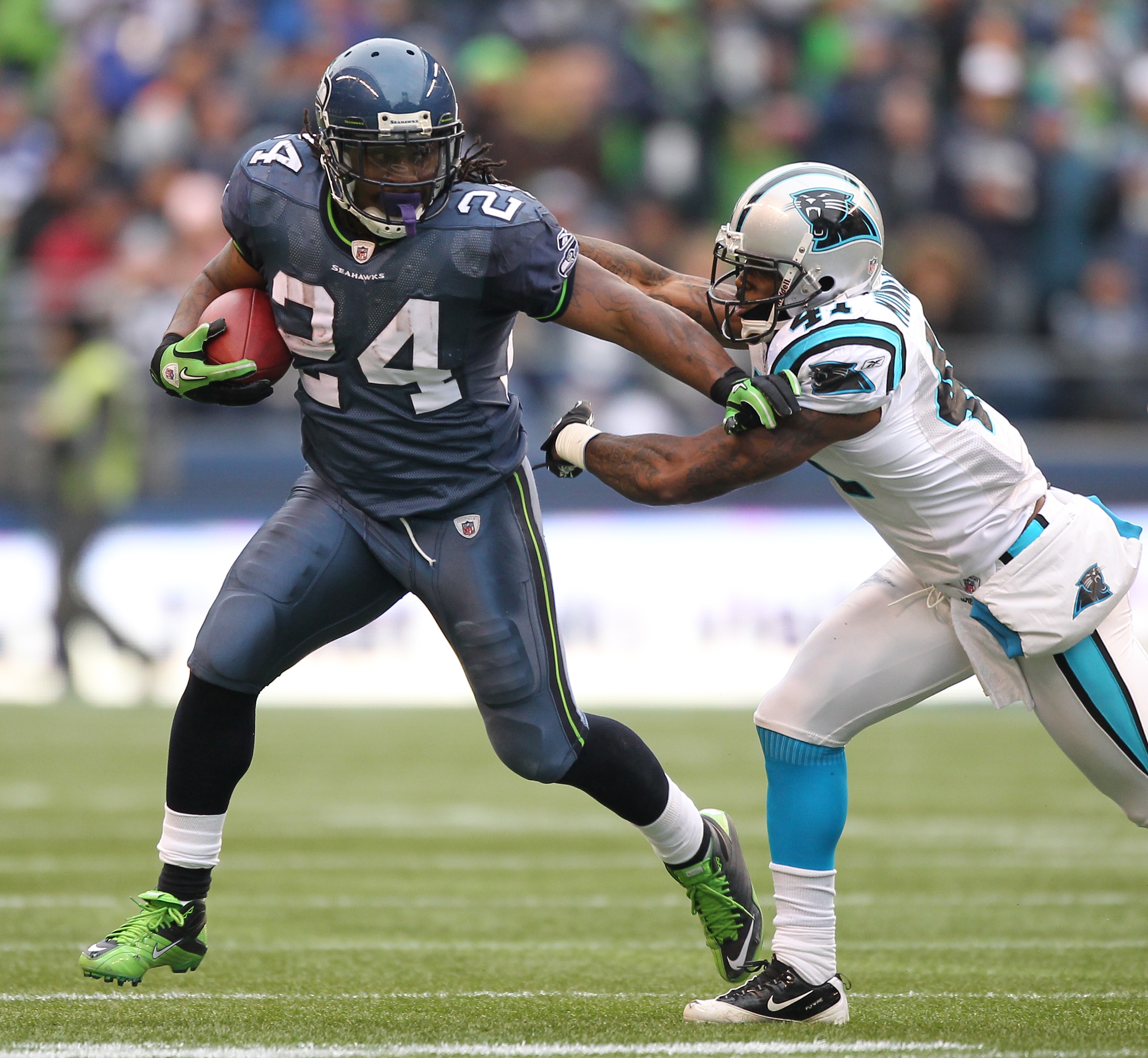 SEATTLE - DECEMBER 05:  Running back Marshawn Lynch #24 of the Seattle Seahawks rushes against Captain Munnerlyn #41 of the Carolina Panthers at Qwest Field on December 5, 2010 in Seattle, Washington. The Seahawks defeated the Panthers 31-14. (Photo by Ot