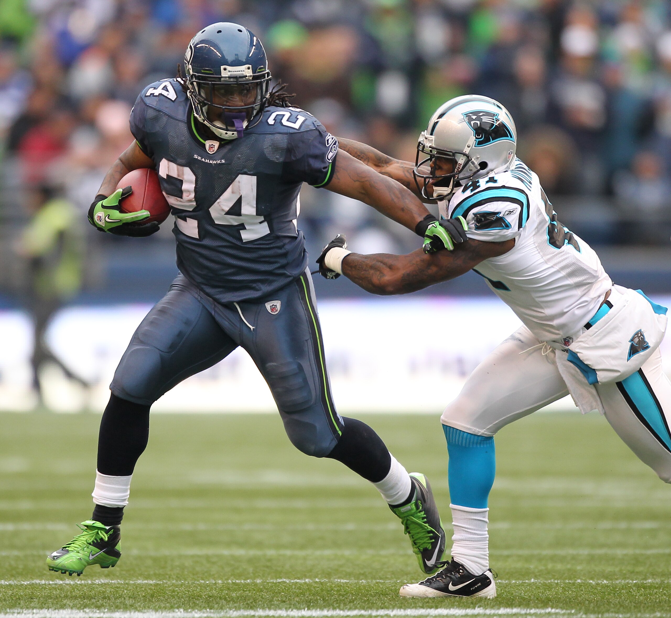 SEATTLE - DECEMBER 05:  Running back Marshawn Lynch #24 of the Seattle Seahawks rushes against Captain Munnerlyn #41 of the Carolina Panthers at Qwest Field on December 5, 2010 in Seattle, Washington. The Seahawks defeated the Panthers 31-14. (Photo by Ot