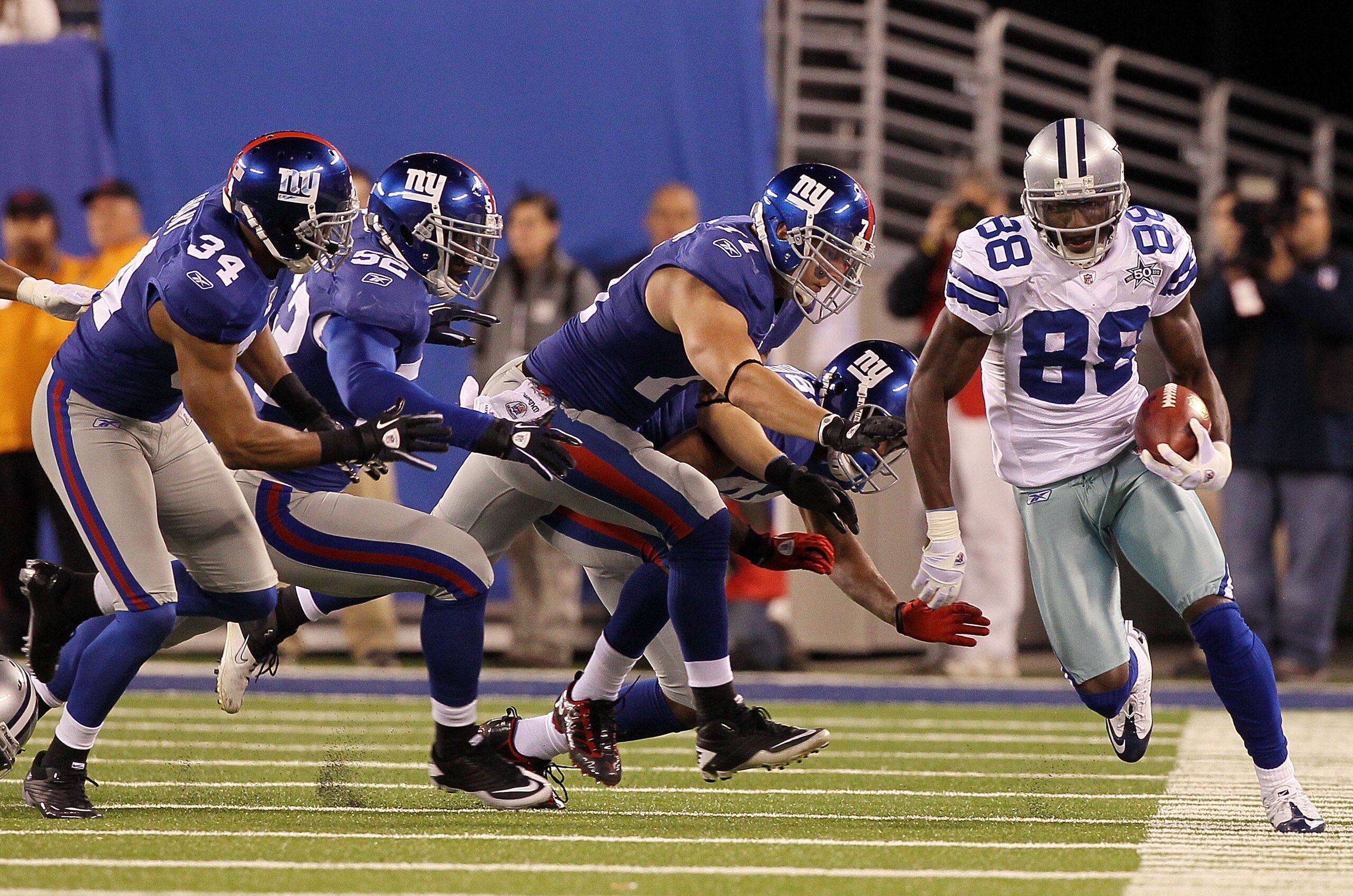 EAST RUTHERFORD, NJ - NOVEMBER 14: Dez Bryant #88 of the Dallas Cowboys runs a kick off past Deon Grant #34, Clint Sintim #52, Dave Tollefson #71, and Duke Calhoun #84 of the New York Giants on November 14, 2010 at the New Meadowlands Stadium in East Ruth