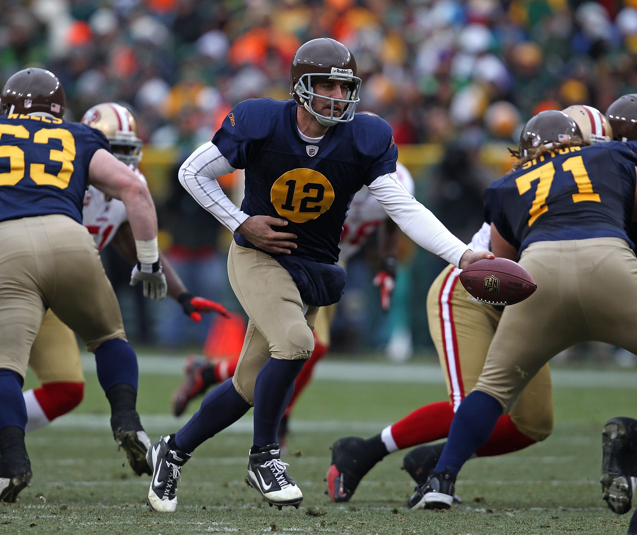 GREEN BAY, WI - DECEMBER 05: Aaron Rodgers #12 of the Green Bay Packers turns to hand off against the San Francisco 49ers at Lambeau Field on December 5, 2010 in Green Bay, Wisconsin. The Packers defeated the 49ers 34-16. (Photo by Jonathan Daniel/Getty I