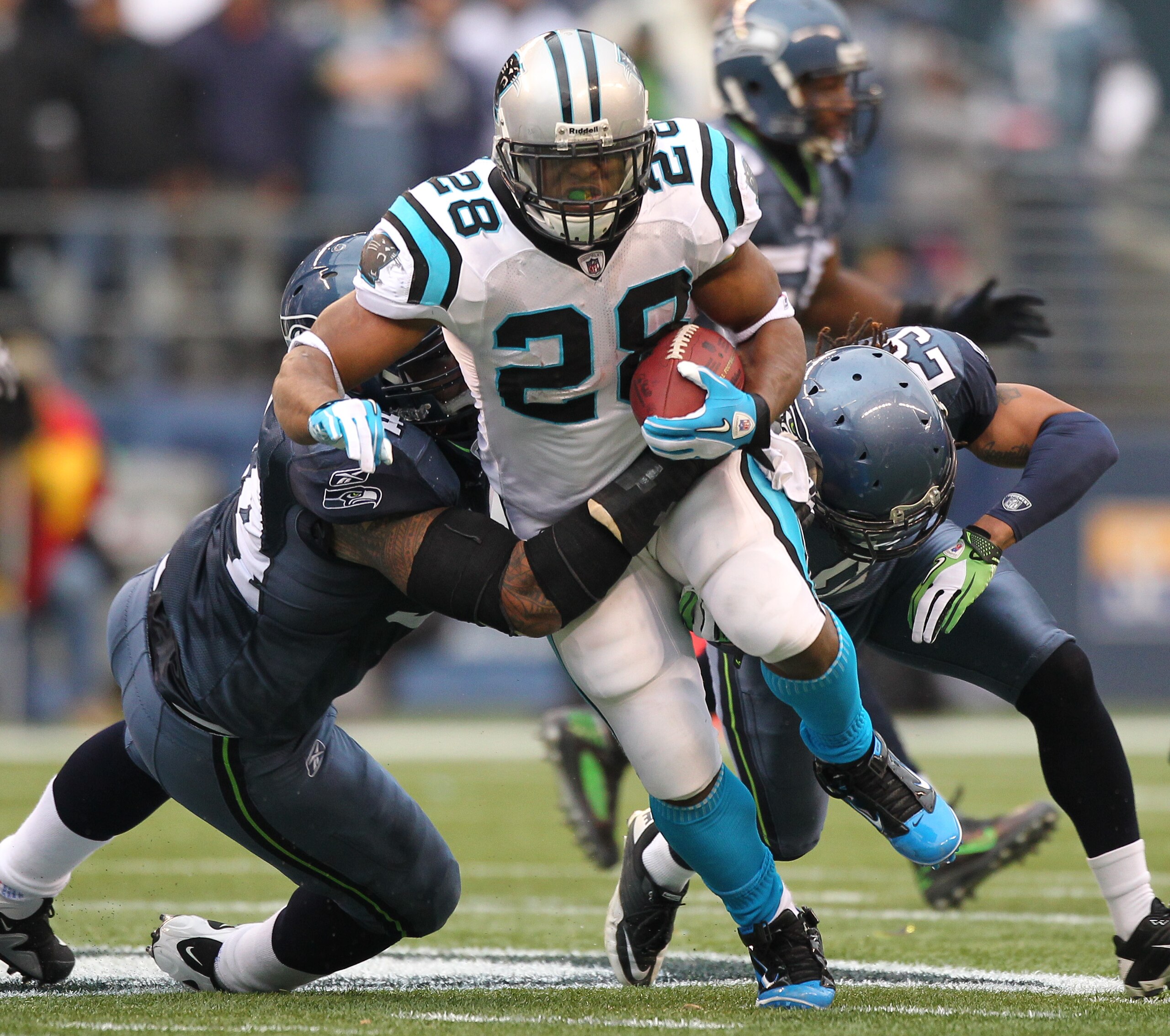 SEATTLE - DECEMBER 05: Running back Jonathan Stewart #28 of the Carolina Panthers rushes against Junior Siavii #94 (L) and Earl Thomas #29 of the Seattle Seahawks at Qwest Field on December 5, 2010 in Seattle, Washington. The Seahawks defeated the Panthe SEATTLE - DECEMBER 05: Running back Jonathan Stewart #28 of the Carolina Panthers rushes against Junior Siavii #94 (L) and Earl Thomas #29 of the Seattle Seahawks at Qwest Field on December 5, 2010 in Seattle, Washington. The Seahawks defeated the Panthe