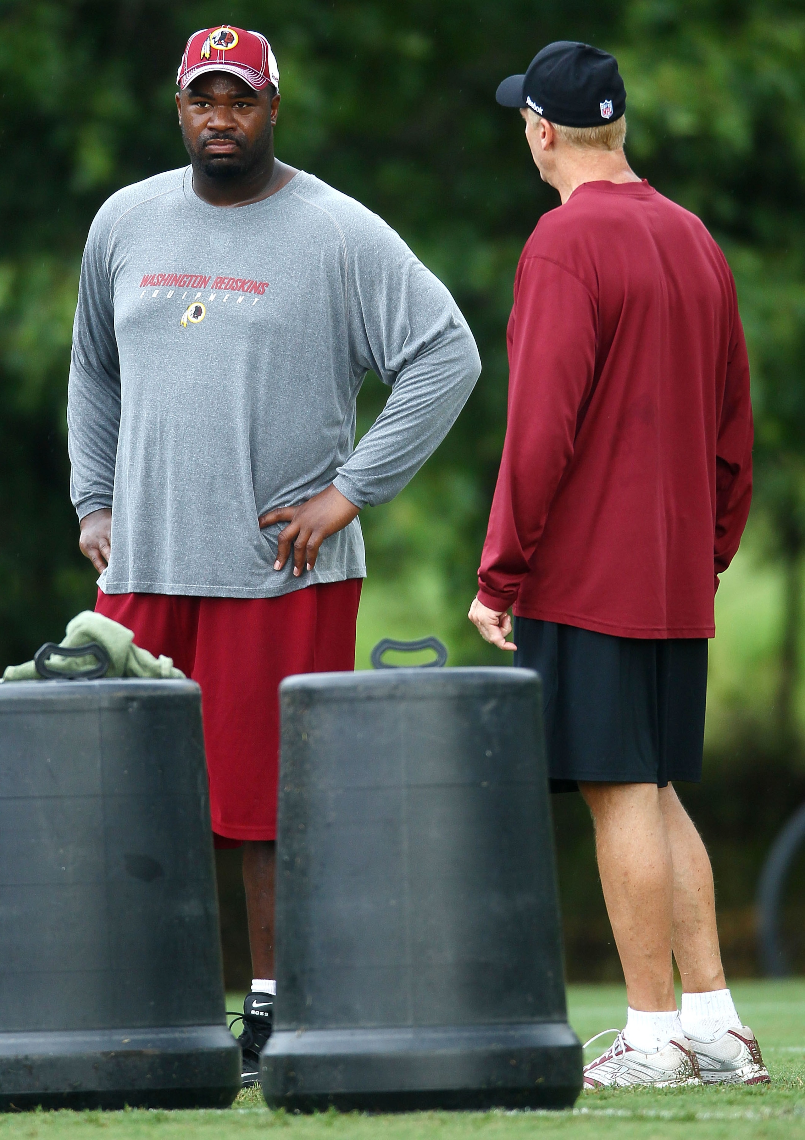 ASHBURN, VA - JULY 29:  Defensive lineman Albert Haynesworth #92 (L) works out with Defensive Coordinator Jim Haslett (R) after the Redskins first day of training camp on July 29, 2010 in Ashburn, Virginia.  (Photo by Win McNamee/Getty Images)