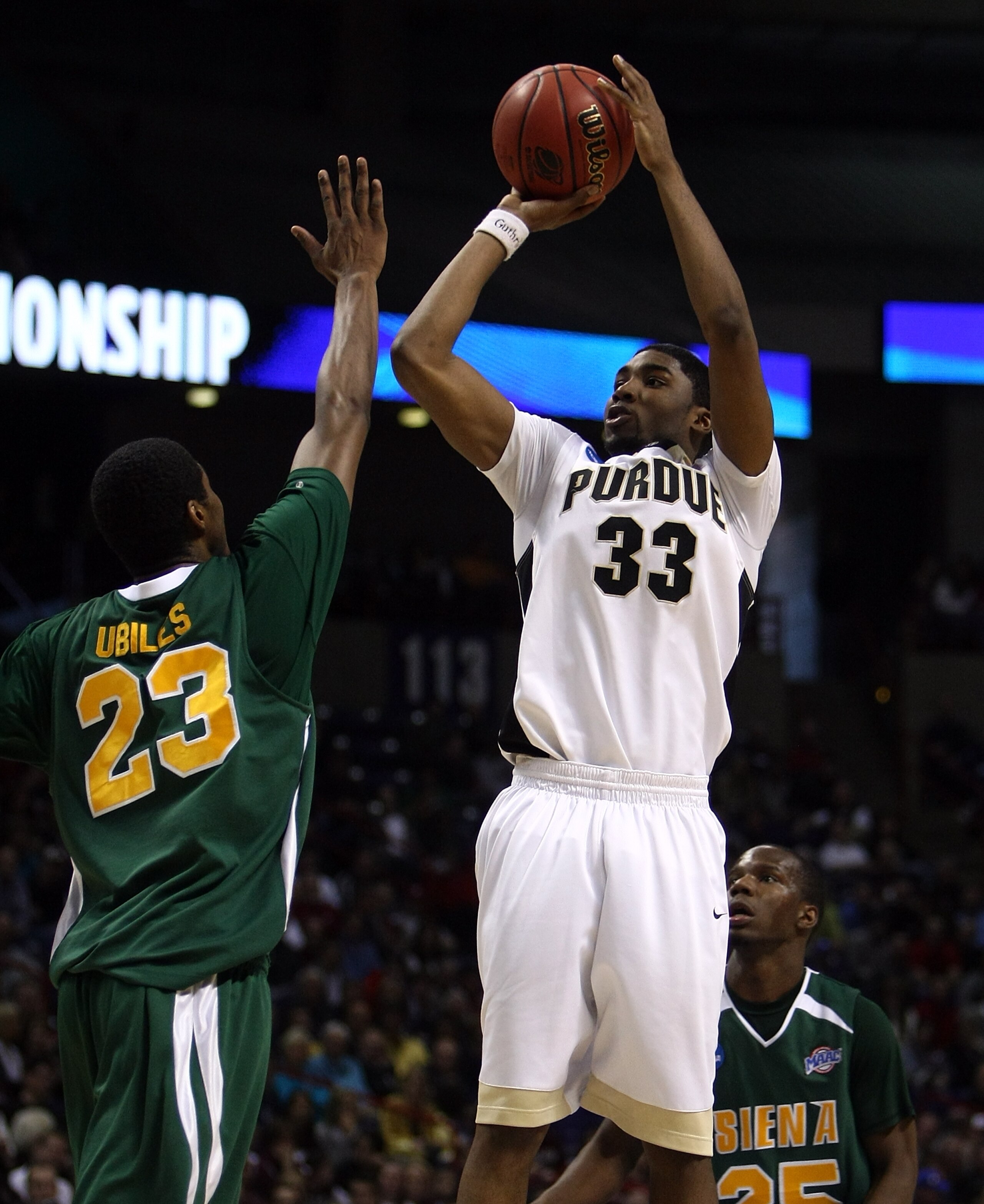 SPOKANE, WA - MARCH 19:  E'Twaun Moore #33 of the Purdue Boilermakers shoots over Edwin Ubiles #23 of the Siena Saints during the first round of the 2010 NCAA men's basketball tournament at Spokane Arena on March 19, 2010 in Spokane, Washington.  (Photo b