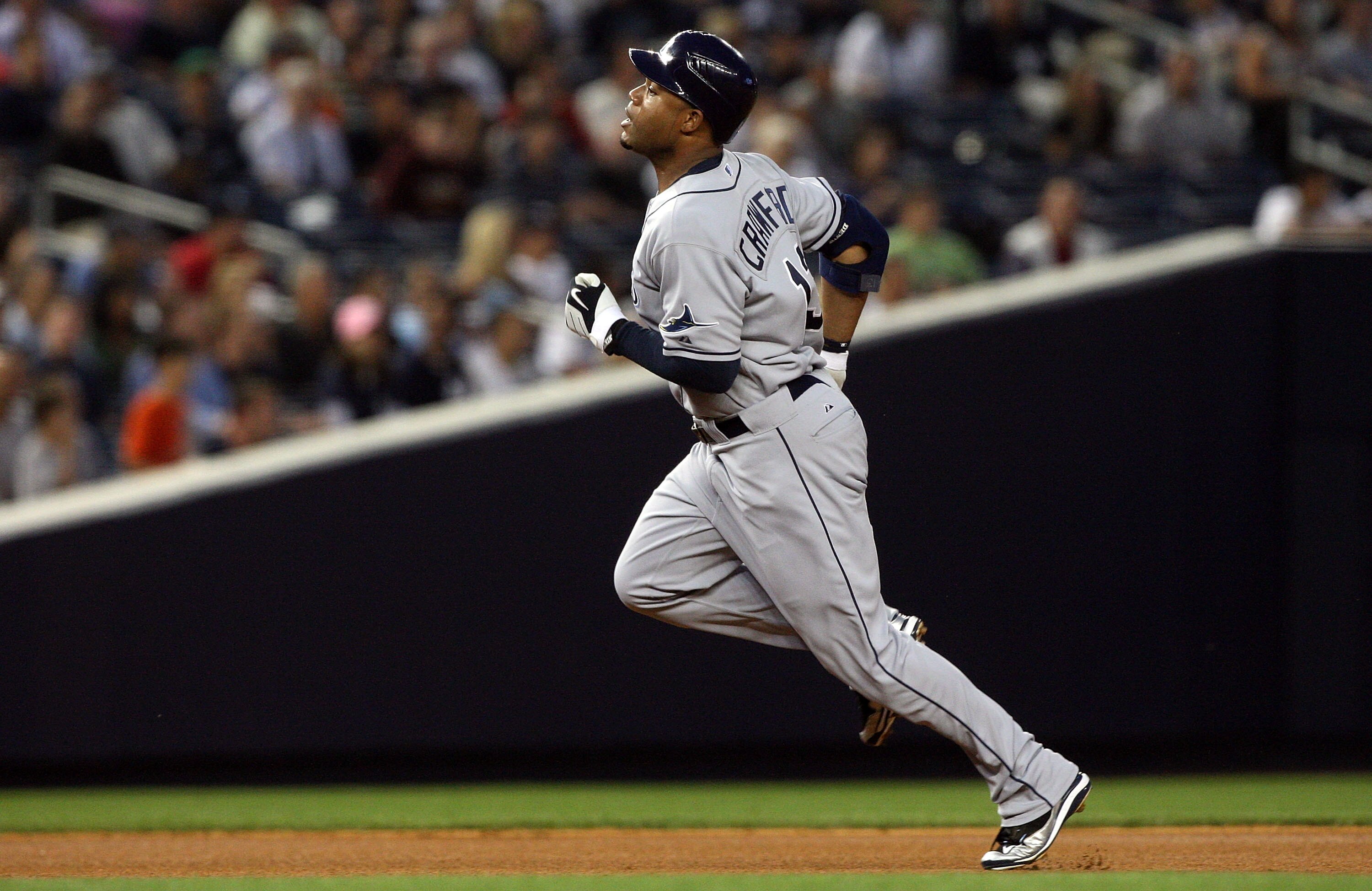 NEW YORK - SEPTEMBER 08:  Carl Crawford #13 of the Tampa Bay Rays runs to third base after his first inning triple against the New York Yankees on September 8, 2009 at Yankee Stadium in the Bronx borough of New York City.  (Photo by Jim McIsaac/Getty Imag