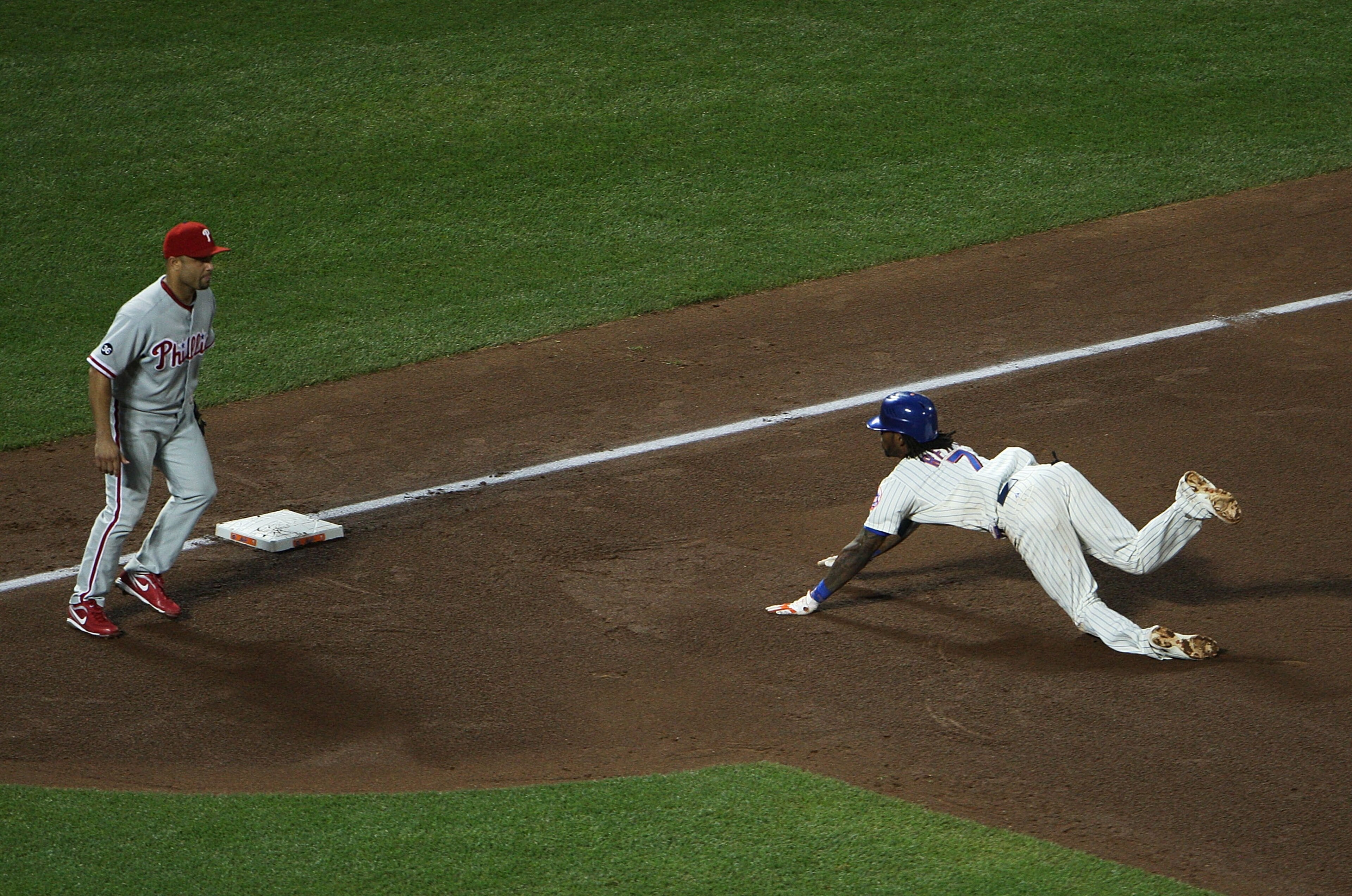 NEW YORK - AUGUST 14: Jose Reyes #7 of the New York Mets slides into third to complete a triple play during the bottom of the fourth inning while playing against the Philadelphia Phillies at Citi Field on August 14, 2010 in the Flushing neighborhood of th NEW YORK - AUGUST 14: Jose Reyes #7 of the New York Mets slides into third to complete a triple play during the bottom of the fourth inning while playing against the Philadelphia Phillies at Citi Field on August 14, 2010 in the Flushing neighborhood of th