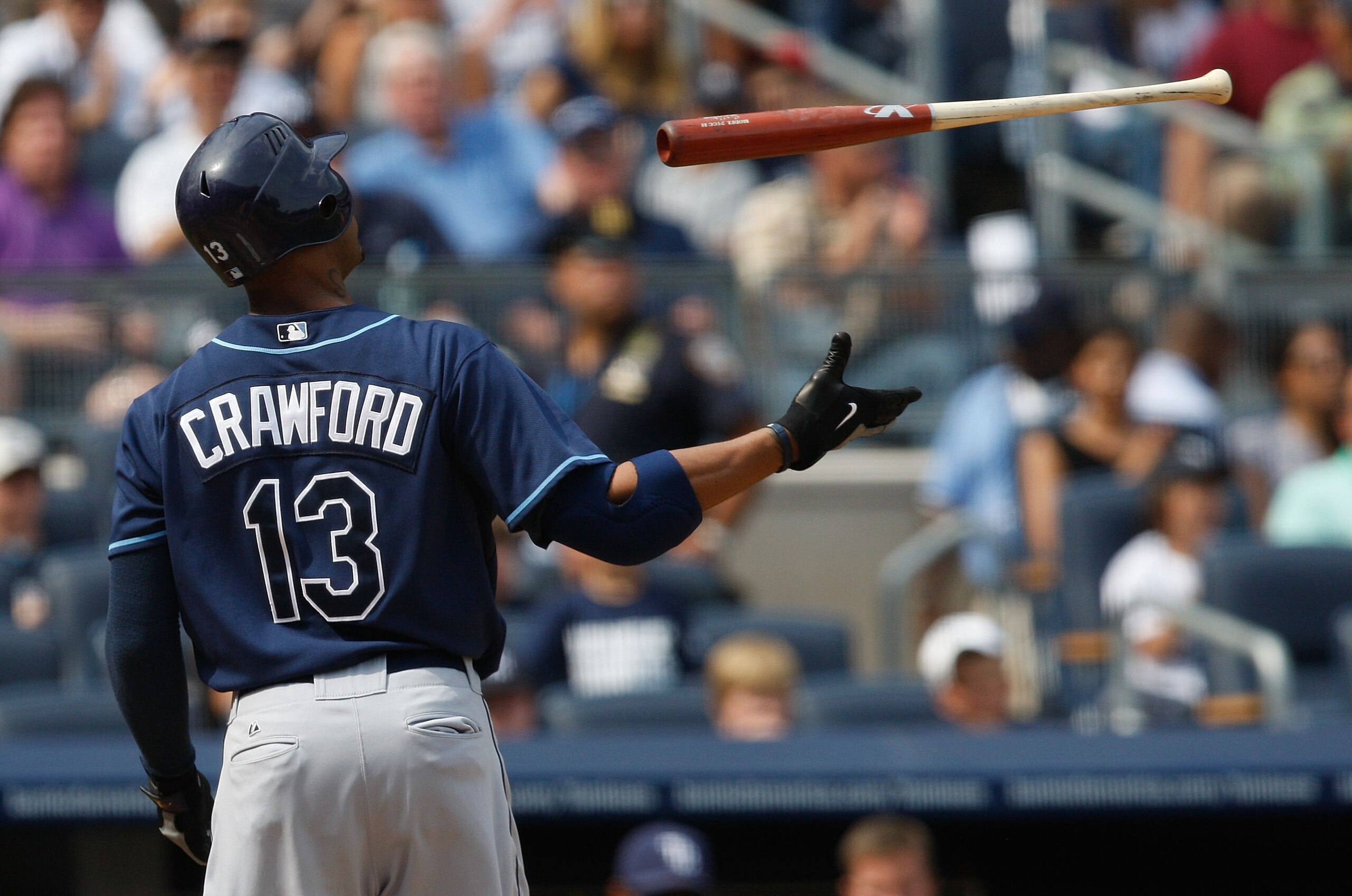 NEW YORK - SEPTEMBER 07:  Carl Crawford #13 of the Tampa Bay Rays throws hit bat in the air during the game against the New York Yankees on September 7, 2009 at Yankee Stadium in the Bronx borough of New York City.  (Photo by Jared Wickerham/Getty Images)