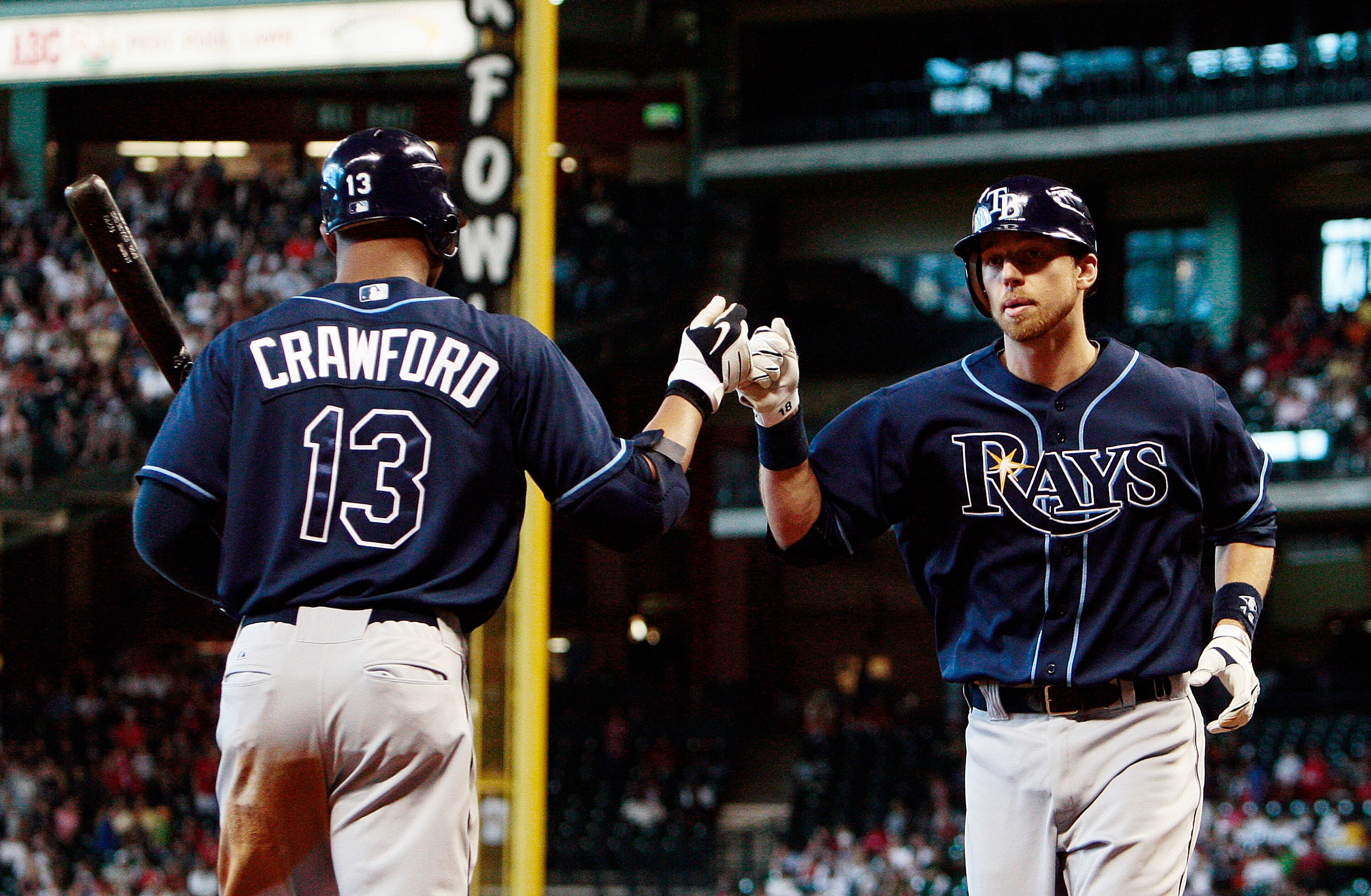 HOUSTON - MAY 23:  Ben Zobrist #18 of the Tampa Bay Rays receives congratulations from Carl Crawford #13 after hitting a solo home run in the third inning against the Houston Astros at Minute Maid Park on May 23, 2010 in Houston, Texas.  (Photo by Bob Lev