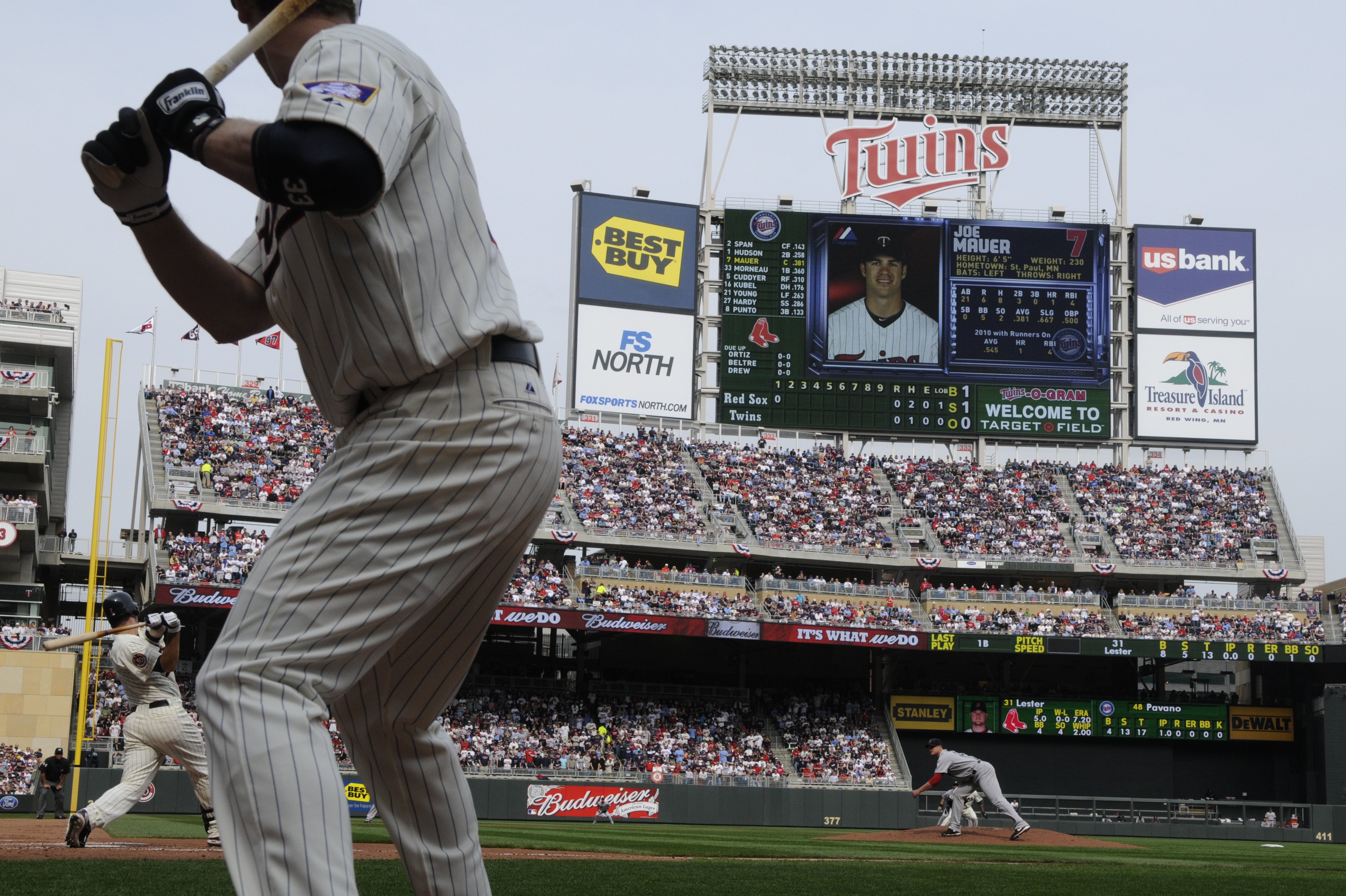 MINNEAPOLIS, MN - APRIL 12: Joe Mauer #7 of the Minnesota Twins bats with Justin Morneau #33 in the on deck circle in the first inning against Jon Lester #31 of the Boston Red Sox during the Twins home opener at Target Field on April 12, 2010 in Minneapol