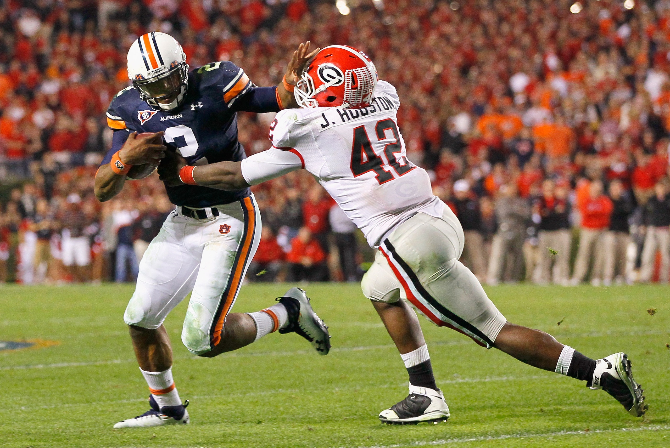 AUBURN, AL - NOVEMBER 13:  Quarterback Cameron Newton #2 of the Auburn Tigers breaks a tackle by Justin Houston #42 of the Georgia Bulldogs at Jordan-Hare Stadium on November 13, 2010 in Auburn, Alabama.  (Photo by Kevin C. Cox/Getty Images)