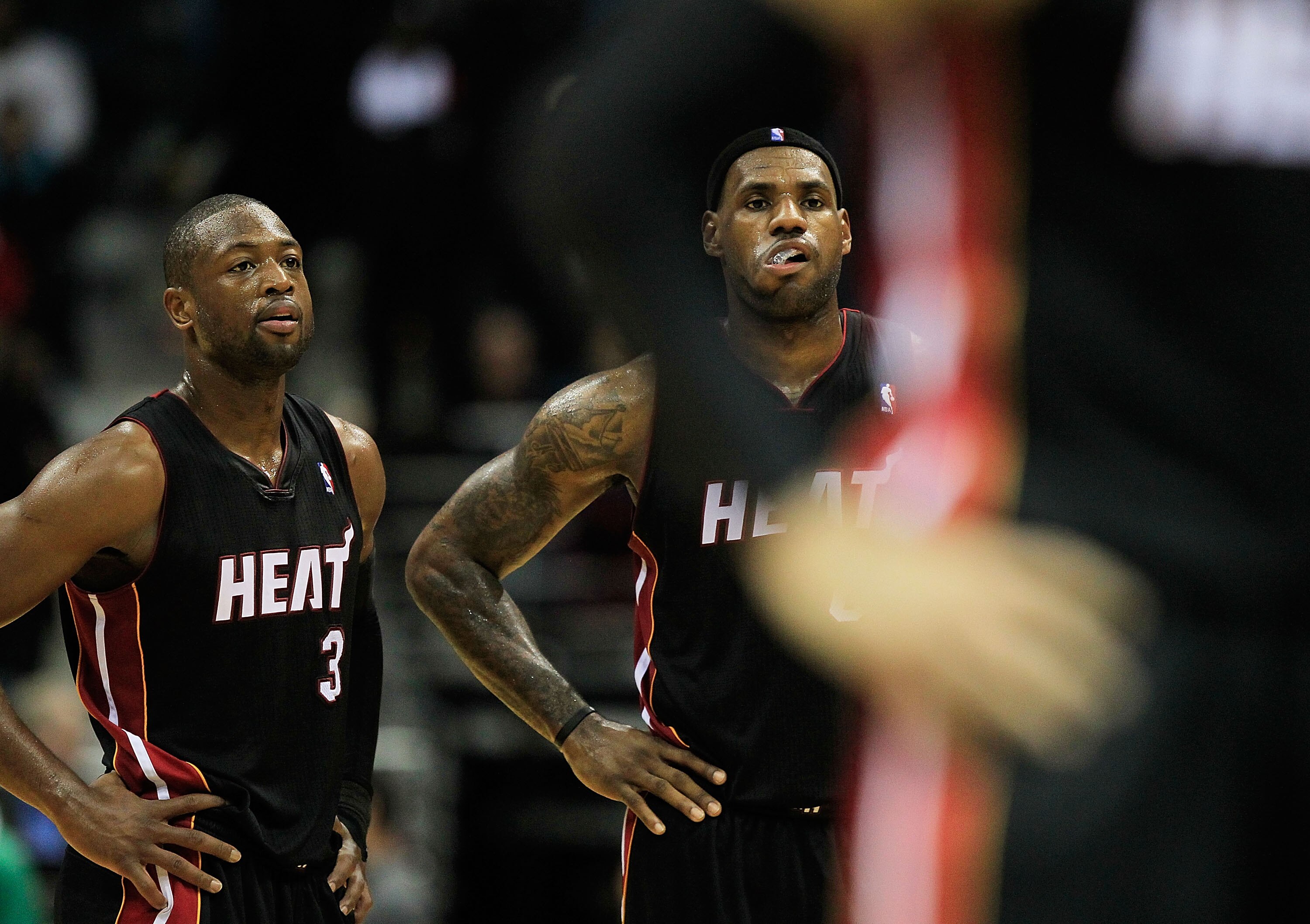 MILWAUKEE, WI - DECEMBER 06: (L-R) Dwyane Wade #3 and LeBron James #6 of the Miami Heat watch as a teammate readies to shoot a free-throw against the Milwaukee Bucks at the Bradley Center on December 6, 2010 in Milwaukee, Wisconsin. The Heat defeated the