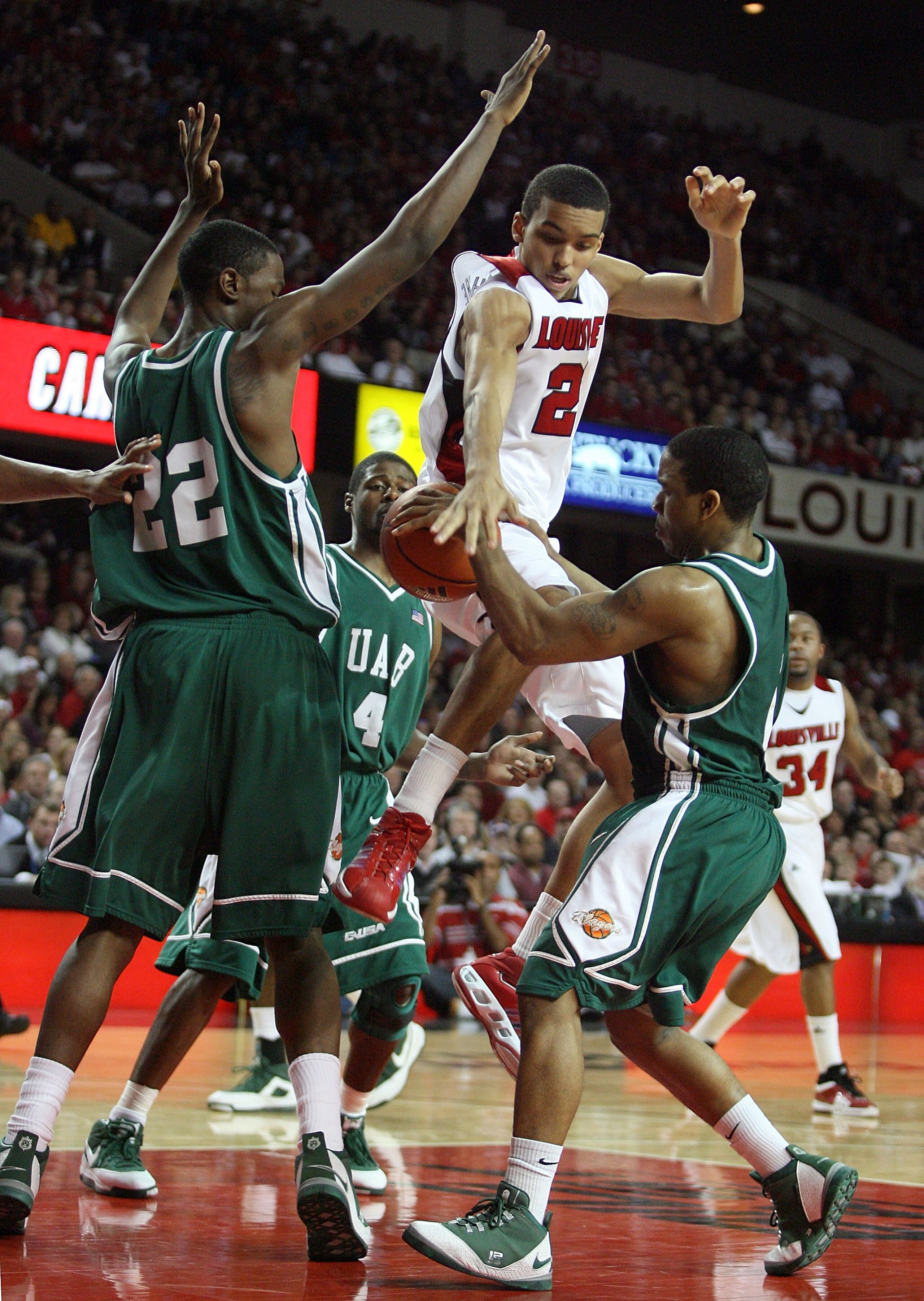 LOUISVILLE, KY - DECEMBER 27: Jared Swopshire #21 of the Louisville Cardinals looses control of the ball while defended by Cameron Moore #22 and Aaron Johnson #1 of the UAB Blazers during the game on December 27, 2008 at Freedom Hall in Louisville, Kentuc