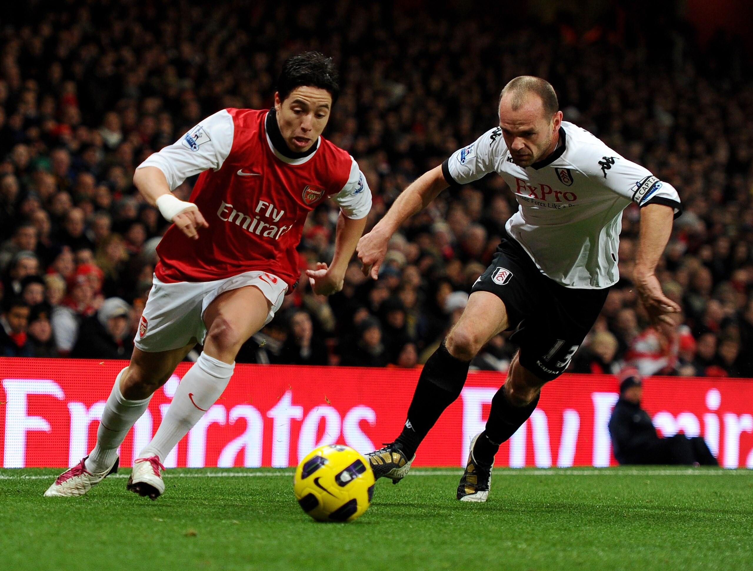 LONDON, ENGLAND - DECEMBER 04:  Samir Nasri of Arsenal (L) in action against Danny Murphy of Fulham during the Barclays Premier League match between Arsenal and Fulham at the Emirates Stadium on December 4, 2010 in London, England.  (Photo by Mike Hewitt/