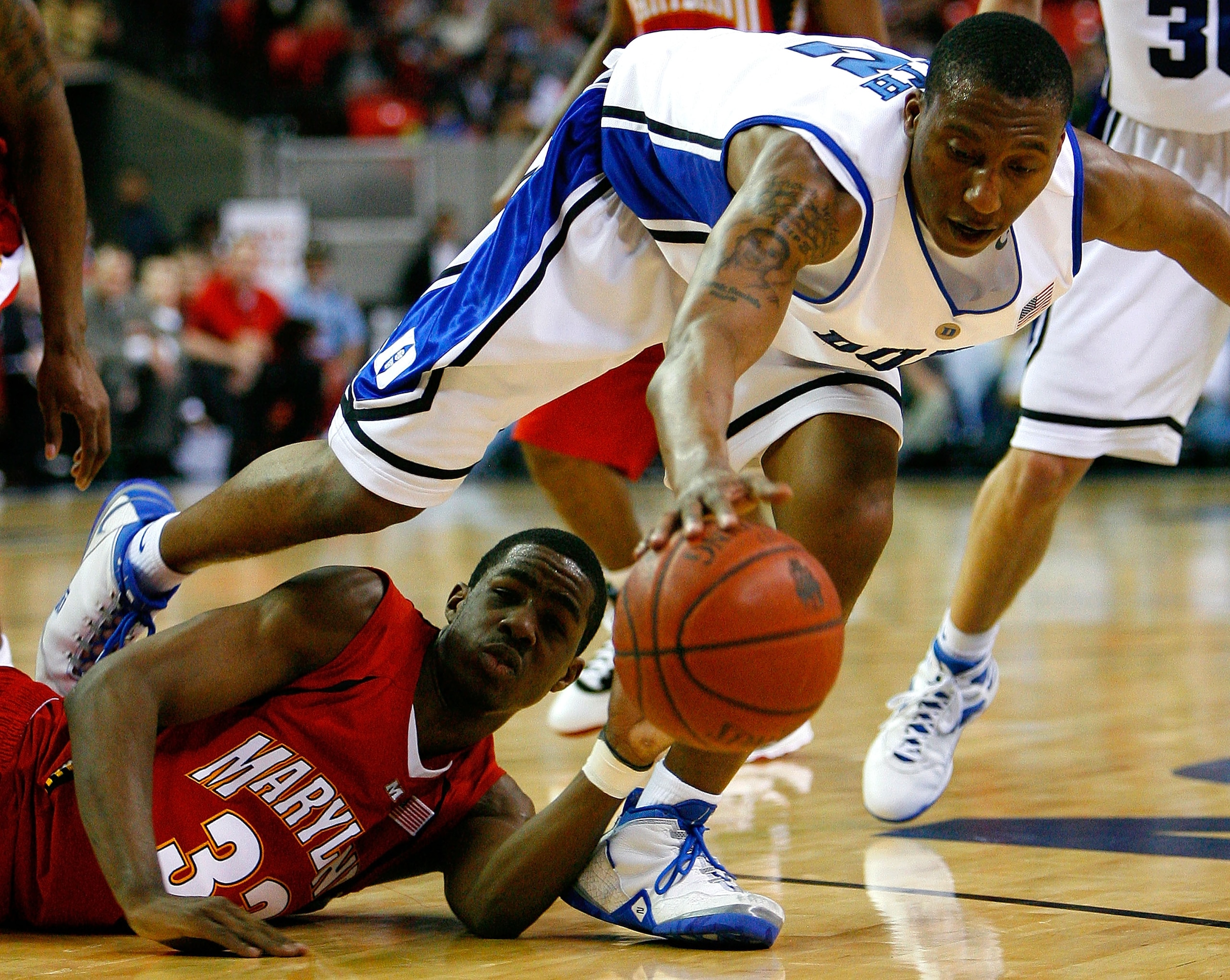 ATLANTA - MARCH 14:  Nolan Smith #2 of the Duke Blue Devils grabs a loose ball against Dino Gregory #33 of the Maryland Terrapins during the semifinals of the 2009 ACC Men's Basketball Tournament on March 14, 2009 at the Georgia Dome in Atlanta, Georgia.