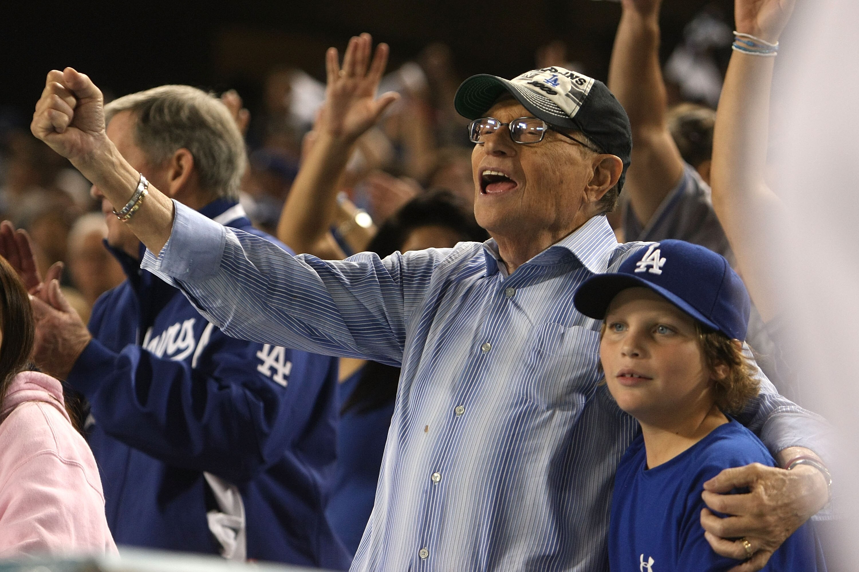 LOS ANGELES, CA - OCTOBER 15:  TV personality Larry King with son cheers on during the seventh inning stretch in Game One of the NLCS between the Philadelphia Phillies and the Los Angeles Dodgers during the 2009 MLB Playoffs at Dodger Stadium on October 1