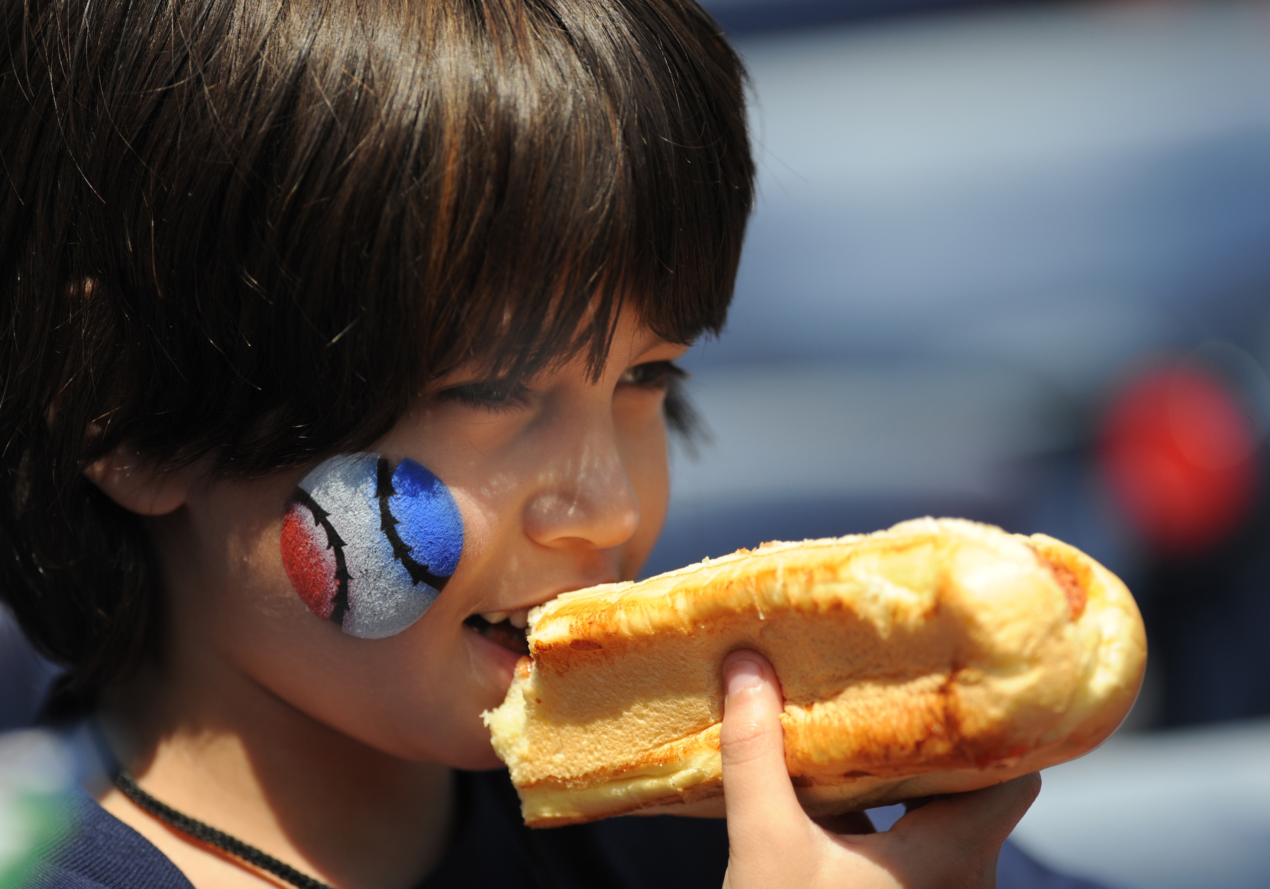 ATLANTA - APRIL 12: A young baseball fan enjoys a hot dog as the Atlanta Braves host the Washington Nationals April 12, 2009 at Turner Field in Atlanta, Georgia.  (Photo by Al Messerschmidt/Getty Images)