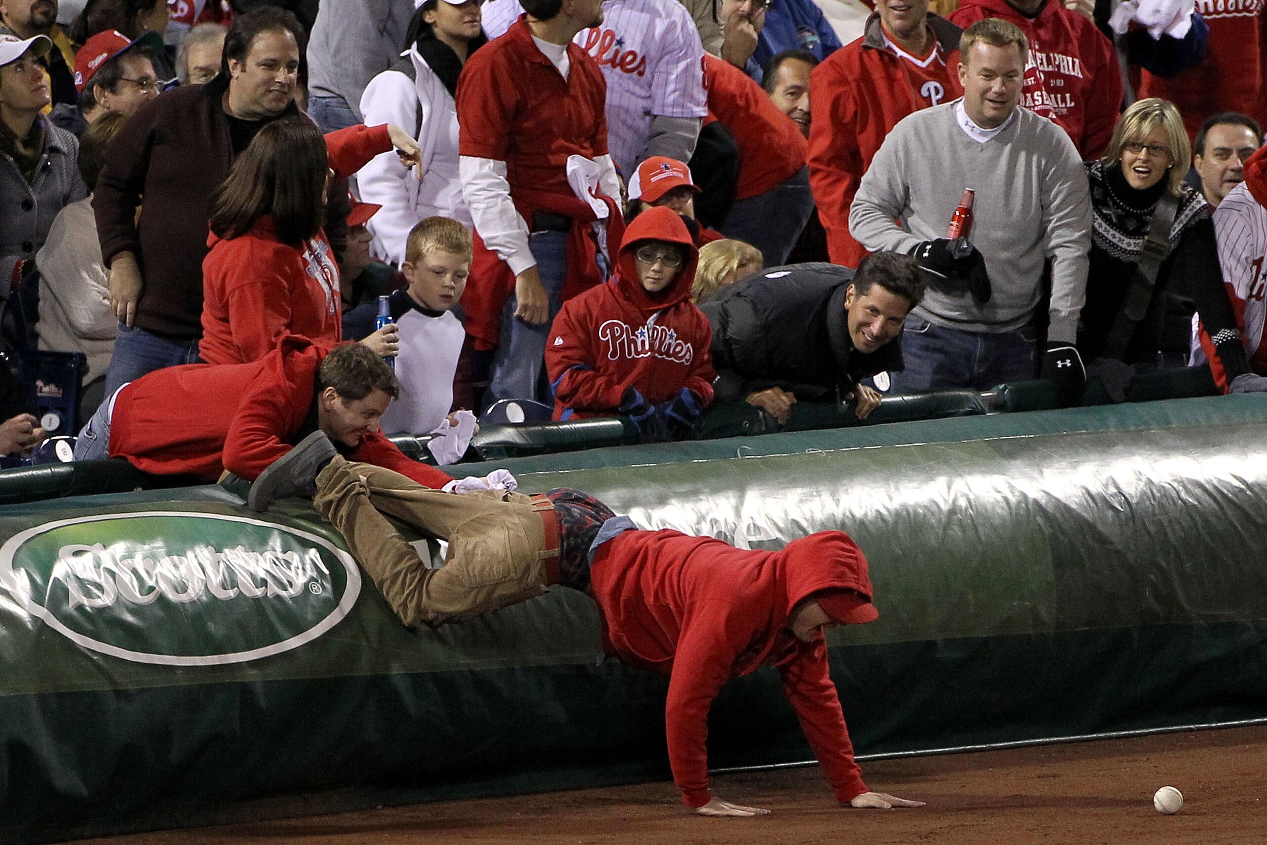 PHILADELPHIA - OCTOBER 16:  A fan goes after a foul ball in Game One of the NLCS during the 2010 MLB Playoffs between the San Francisco Giants and the Philadelphia Phillies at Citizens Bank Park on October 16, 2010 in Philadelphia, Pennsylvania.  (Photo b