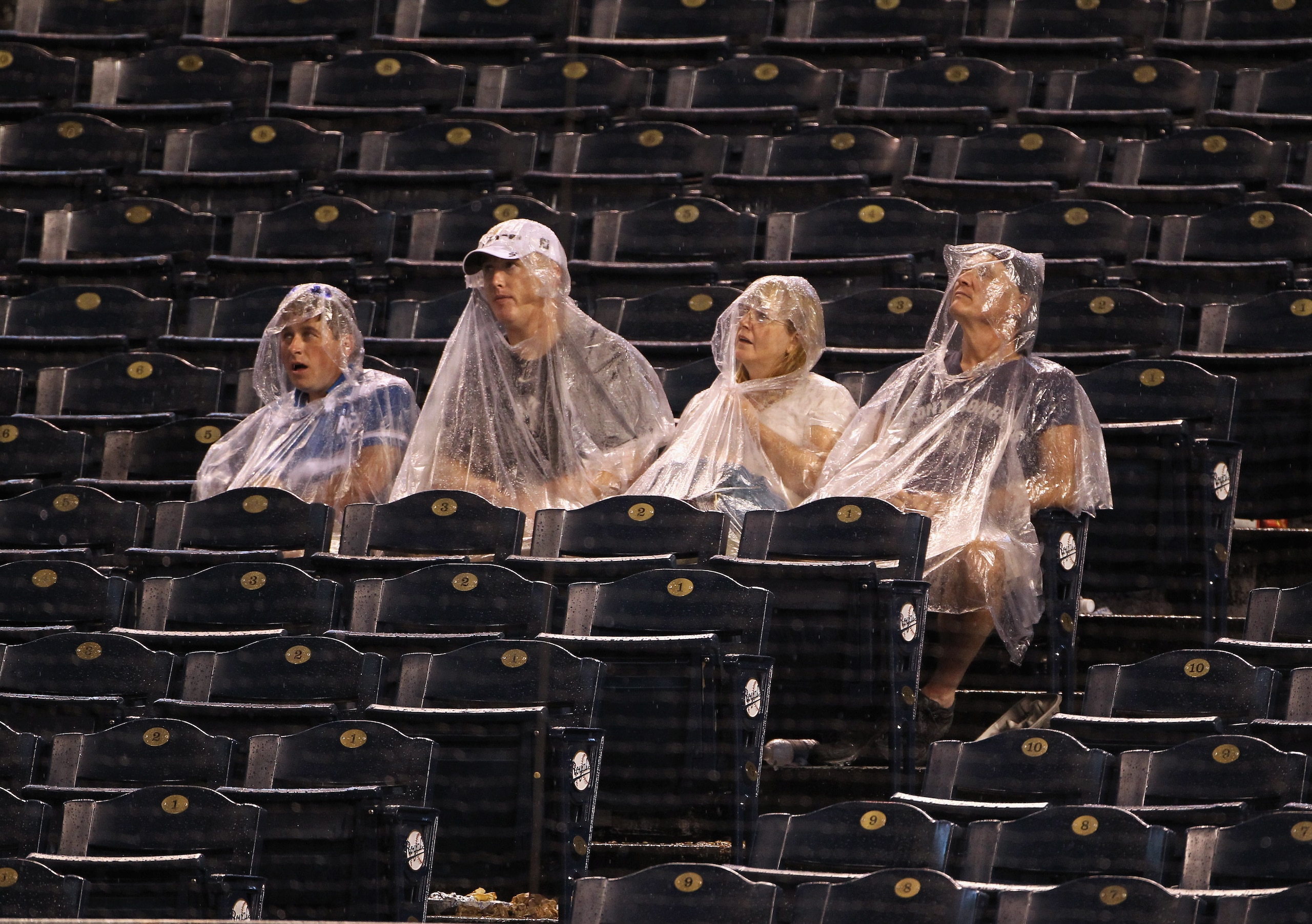 KANSAS CITY, MO - AUGUST 13:  Fans wait in the stands during a rain delay in the game between the New York Yankees and the Kansas City Royals on August 13, 2010 at Kauffman Stadium in Kansas City, Missouri.  (Photo by Jamie Squire/Getty Images)