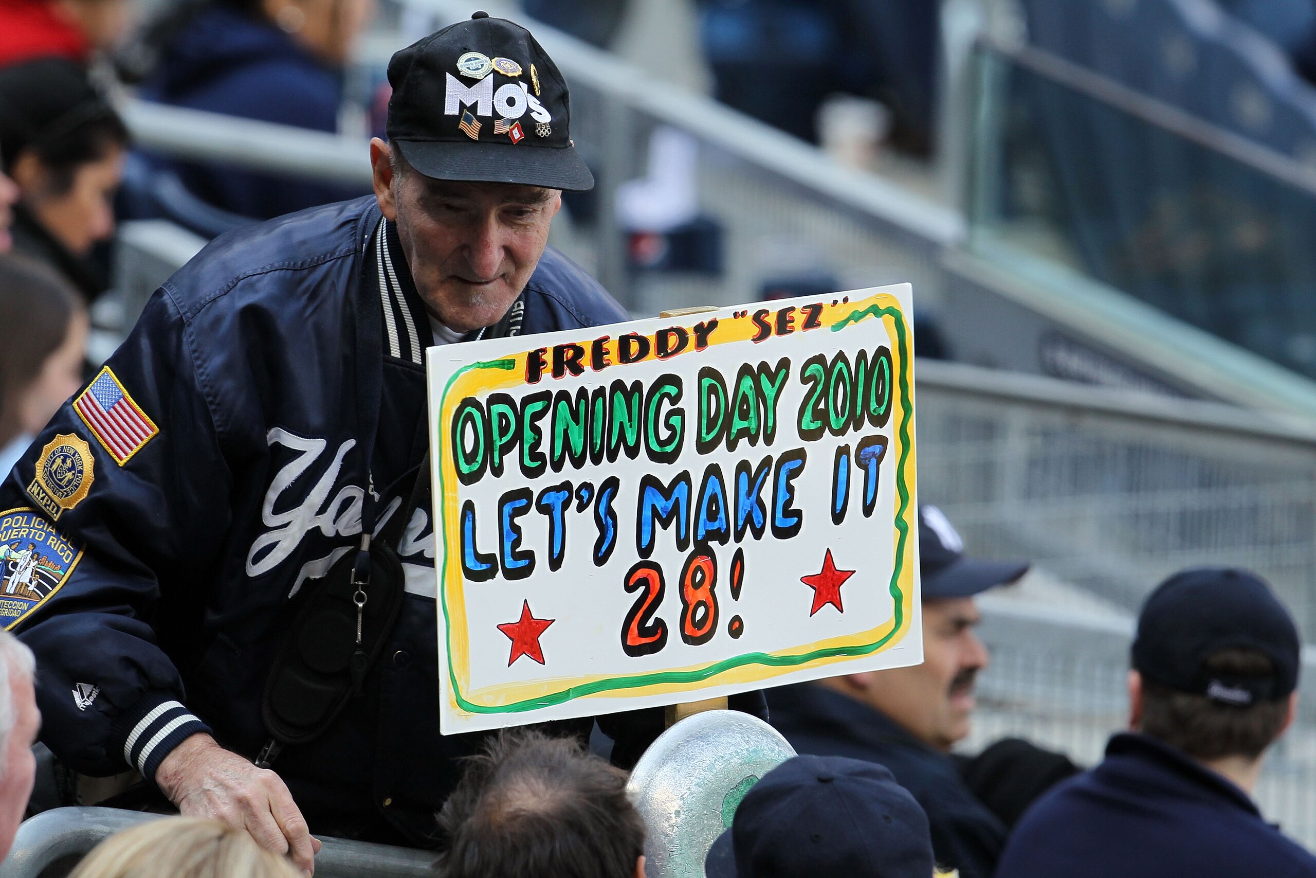 NEW YORK - APRIL 13:  Super fan Freddy Sez holds up a sign reading 'Opening Day 2010 Let's Makes It 28!' as the New York Yankees play against the Los Angeles Angels of Anaheim during the Yankees home opener at Yankee Stadium on April 13, 2010 in the Bronx