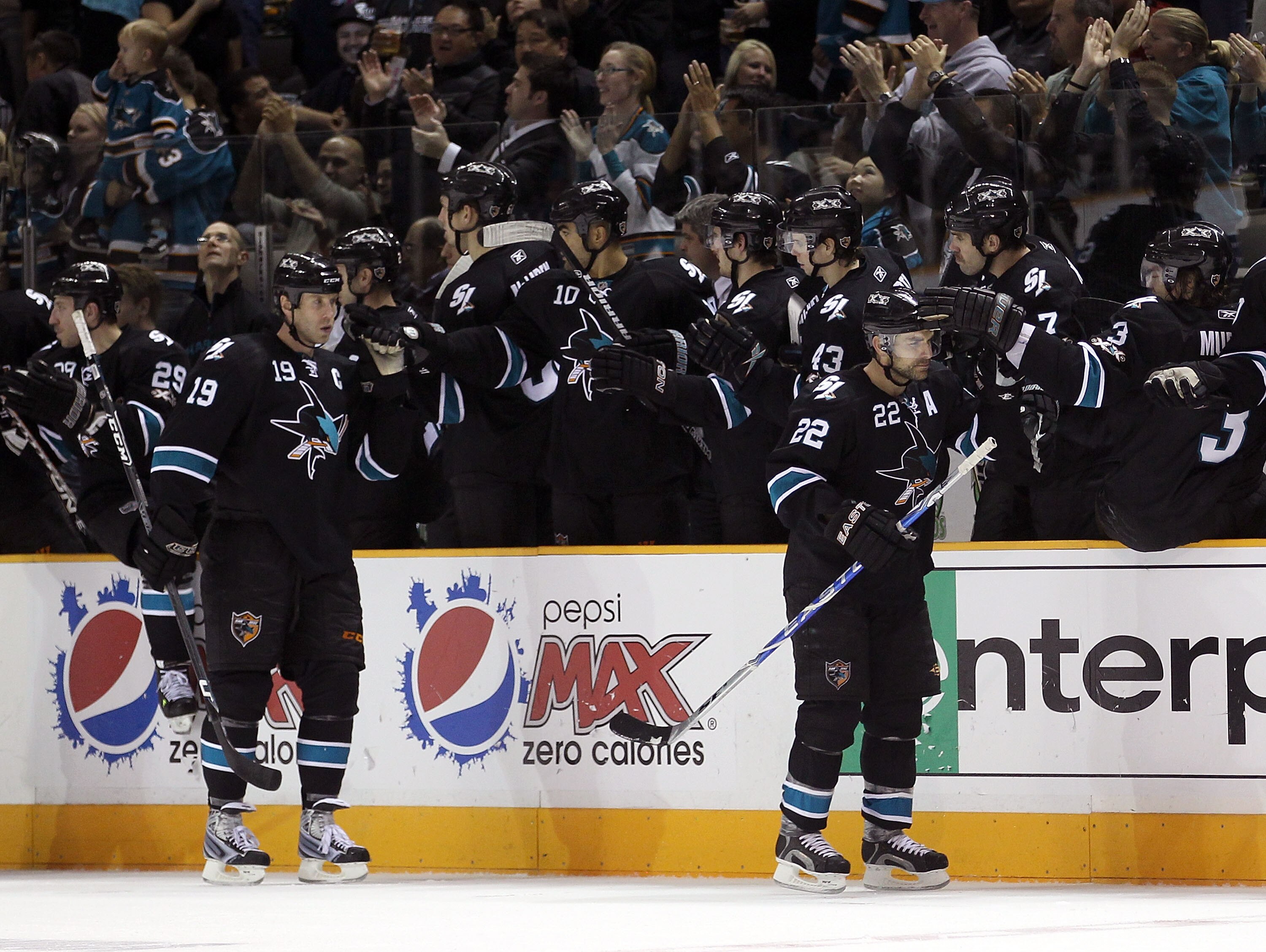 SAN JOSE, CA - NOVEMBER 11:  Dan  Boyle #22 and Joe Thornton #19 of the San Jose Sharks are congratulated by teammates after Boyle scored a goal during their game against the New York Islanders on November 11, 2010 in San Jose, California.  (Photo by Ezra