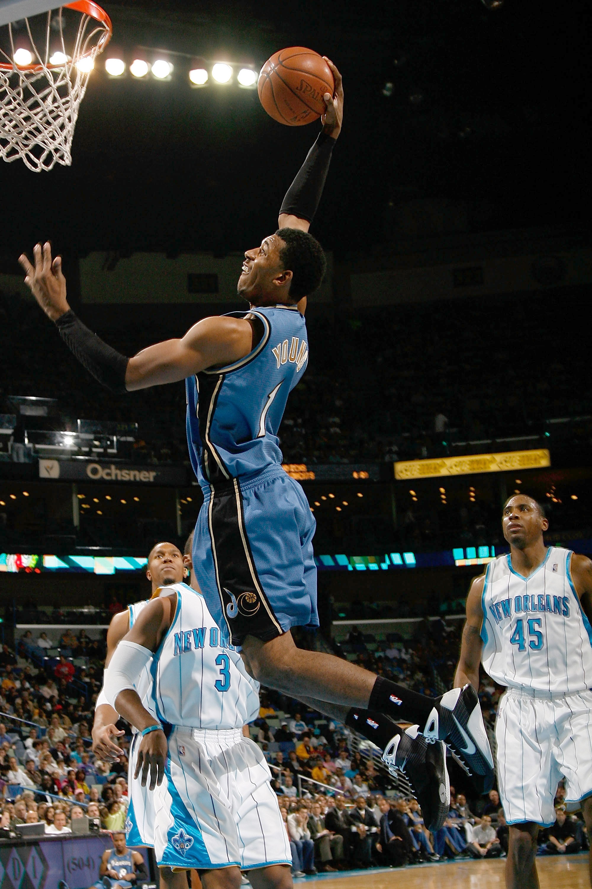 NEW ORLEANS - DECEMBER 30:  Nick Young #1 of the Washington Wizards makes a dunk over Chris Paul #3 of the New Orleans Hornets on December 30, 2008 at the New Orleans Arena in New Orleans, Louisiana.  NOTE TO USER: User expressly acknowledges and agrees t