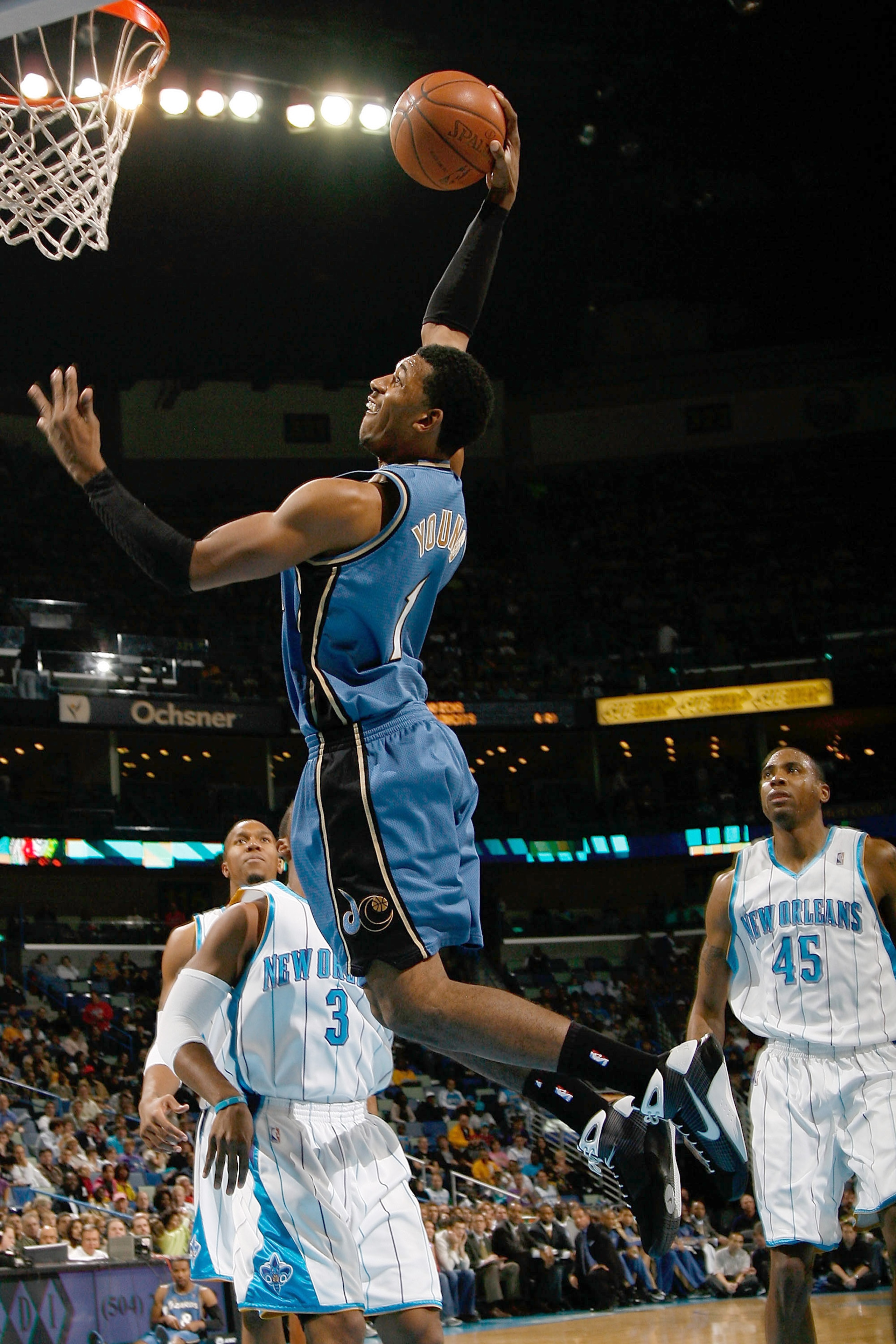 NEW ORLEANS - DECEMBER 30:  Nick Young #1 of the Washington Wizards makes a dunk over Chris Paul #3 of the New Orleans Hornets on December 30, 2008 at the New Orleans Arena in New Orleans, Louisiana.  NOTE TO USER: User expressly acknowledges and agrees t