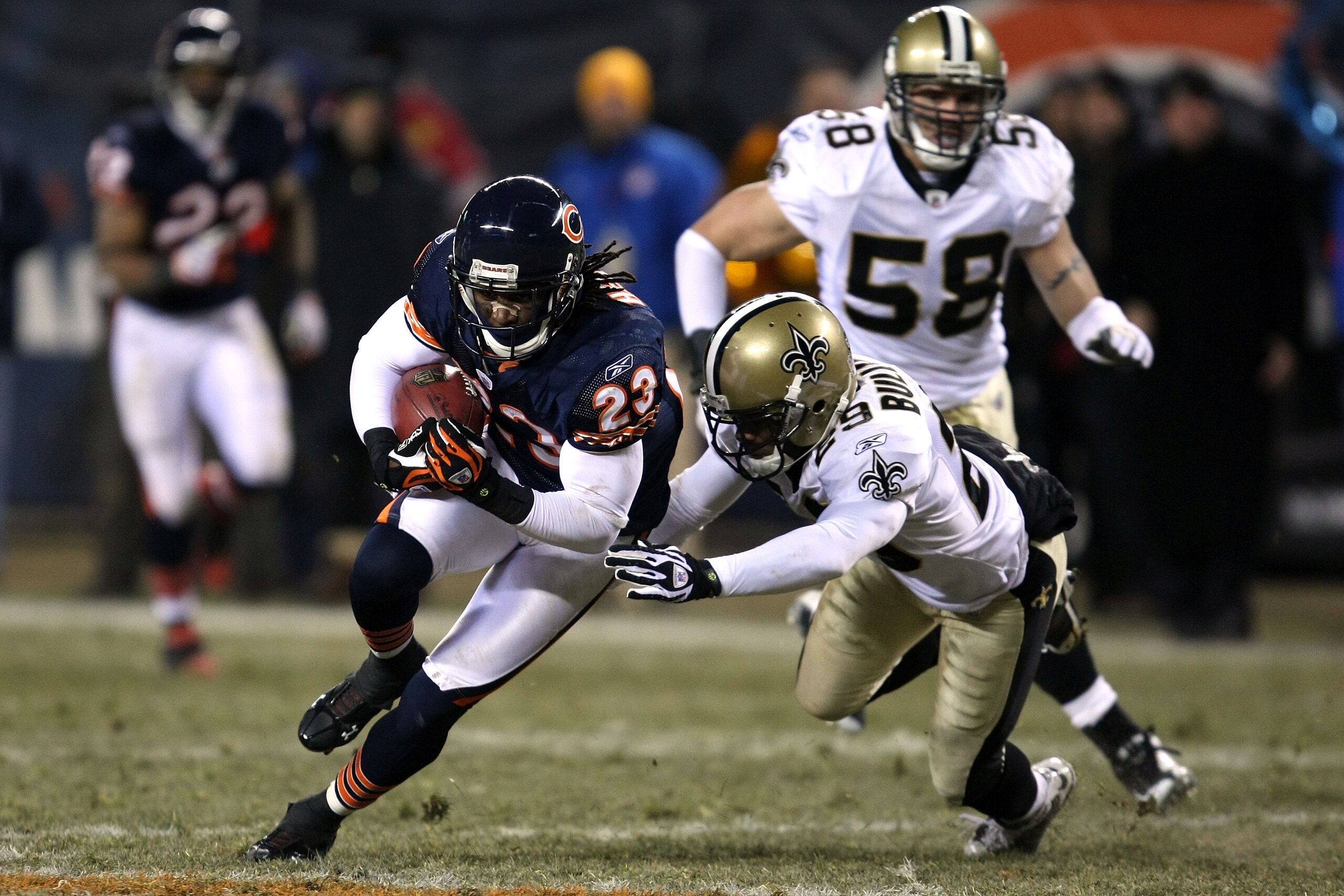 CHICAGO - DECEMBER 11:  Devin Hester #23 of the Chicago Bears runs for yards after the catch against Josh Bullocks #29 of the New Orleans Saints at Soldier Field on December 11, 2008 in Chicago, Illinois. The Bears won 27-24. (Photo by Jonathan Daniel/Get