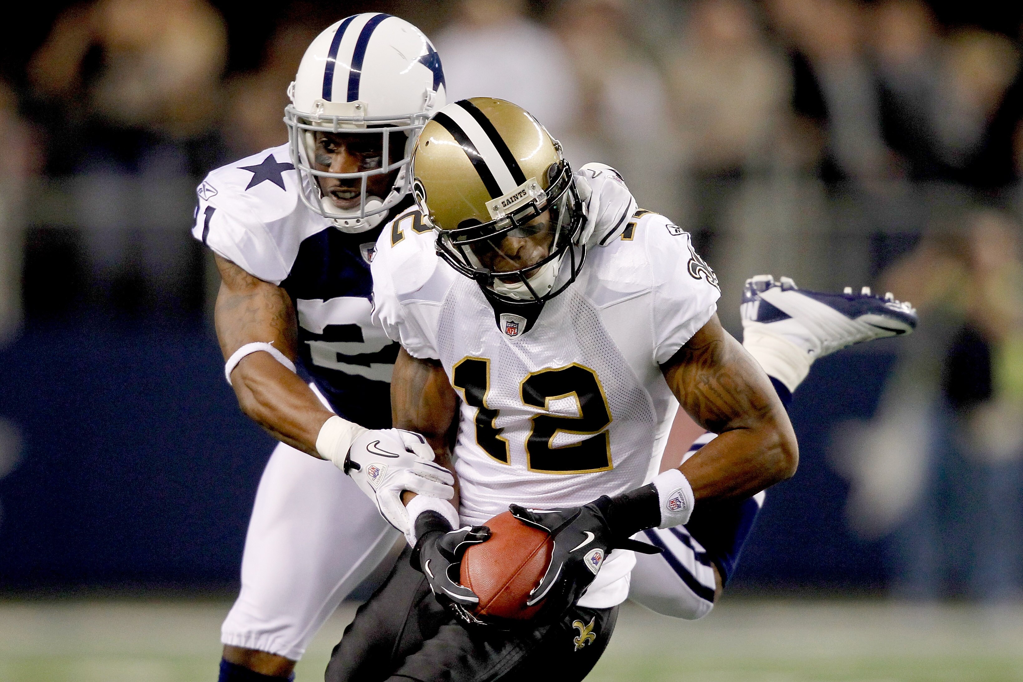 ARLINGTON, TX - NOVEMBER 25: Mike Jenkins #21 of the Dallas Cowboys tackles Marques Colston #12 of the New Orleans Saints at Cowboys Stadium on November 25, 2010 in Arlington, Texas.  (Photo by Matthew Stockman/Getty Images)