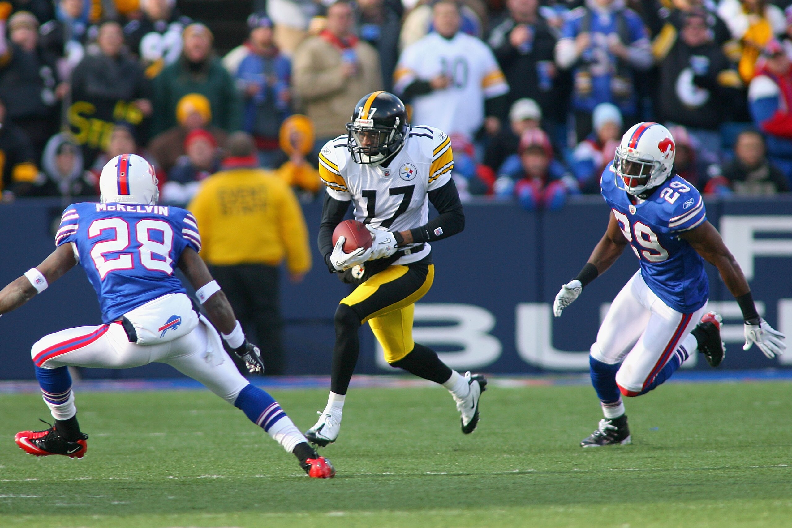 ORCHARD PARK, NY - NOVEMBER 28: Mike Wallace #17 of the Pittsburgh Steelers runs between Leodis McKelvin #28 and Drayton Florence #29 of the Buffalo Bills  at Ralph Wilson Stadium at Ralph Wilson Stadium on November 28, 2010 in Orchard Park, New York. Pit
