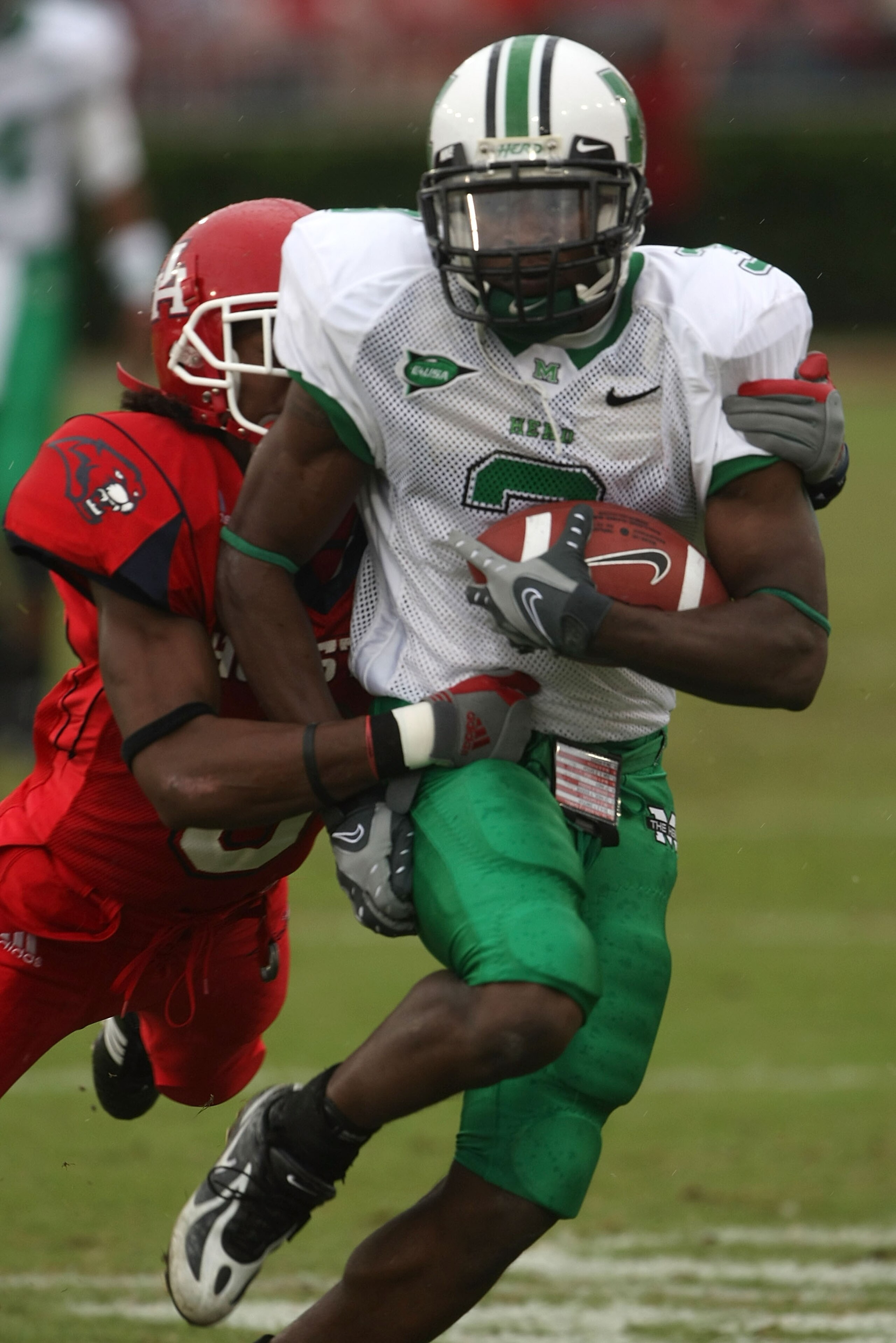 HOUSTON - NOVEMBER 17:  Wide receiver E.J. Wynn #3 of the Marshall Thundering Herd is tackled by cornerback Quinte Williams #8 of the Houston Cougars at Robertson Stadium November 17, 2007 in Houston, Texas. Houston won 35-28.  (Photo by Stephen Dunn/Gett