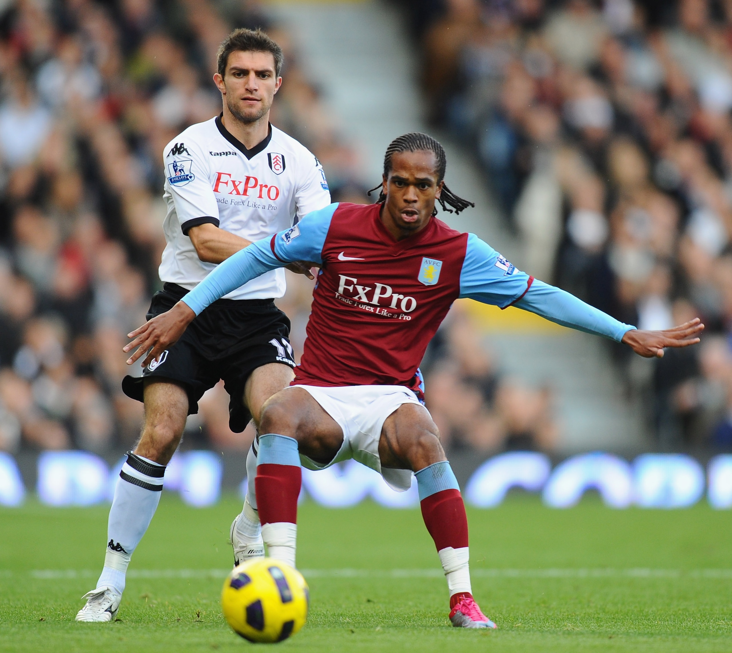LONDON, ENGLAND - NOVEMBER 06:  Nathan Delfouneso of Aston Villa is challenged by Aaron Hughes of Fulham during the Barclays Premier League match between Fulham and Aston Villa at Craven Cottage on November 6, 2010 in London, England.  (Photo by Mike Hewi